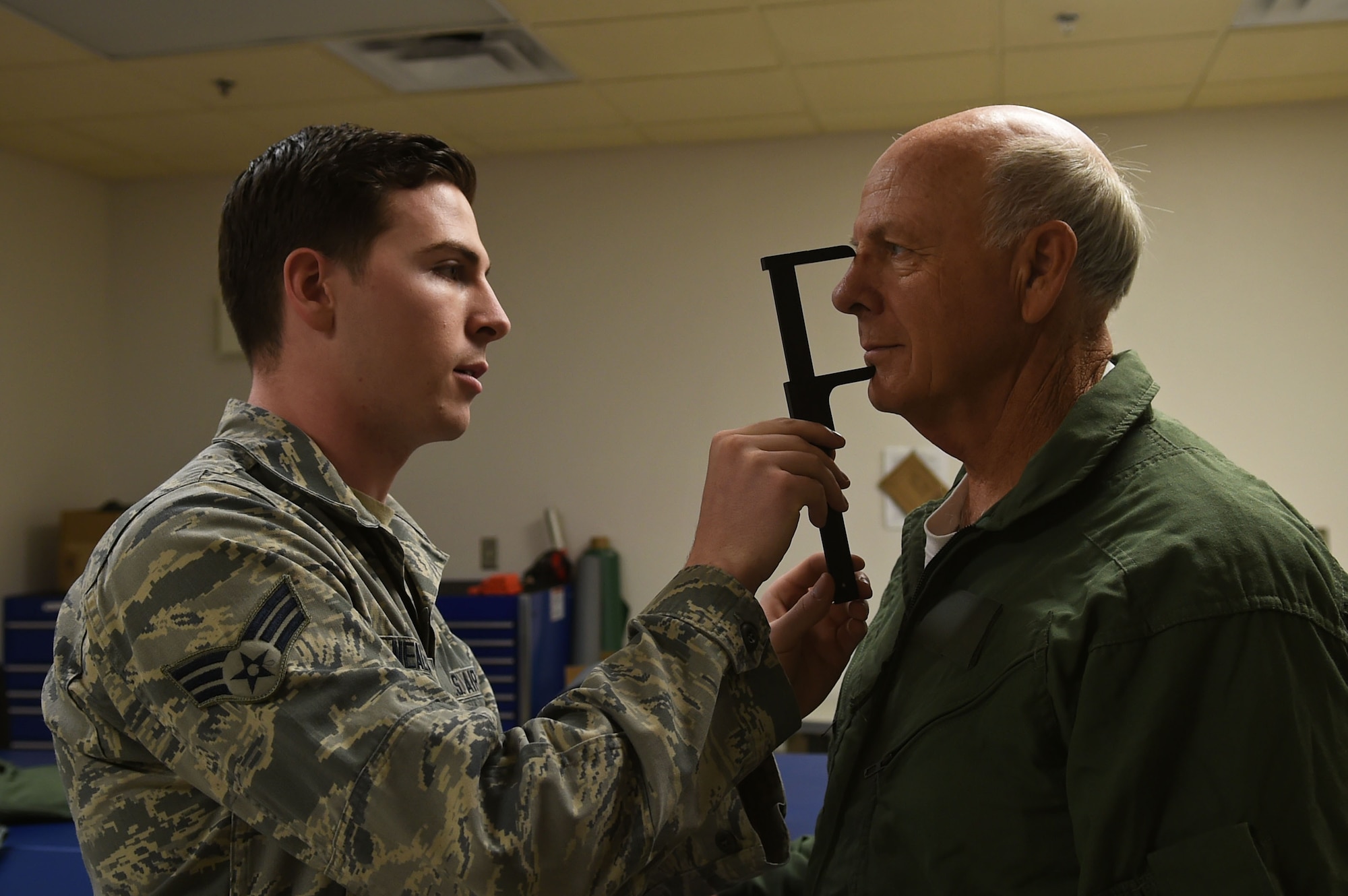 Senior Airman Nicholas Nealeigh, 54th Operation Support Squadron aircrew flight equipment, measures U.S. Rep. Steve Pearce, New Mexico 2nd district, for his face mask prior to his F-16 Orientation flight, Dec. 16, 2016, Holloman Air Force Base, N.M. Pearce was offered an orientation flight on the F-16 Fighting Falcon, to better understand the capabilities and mission of the F-16. (U.S. Air Force photo by Tech. Sgt. Amanda N. Junk)