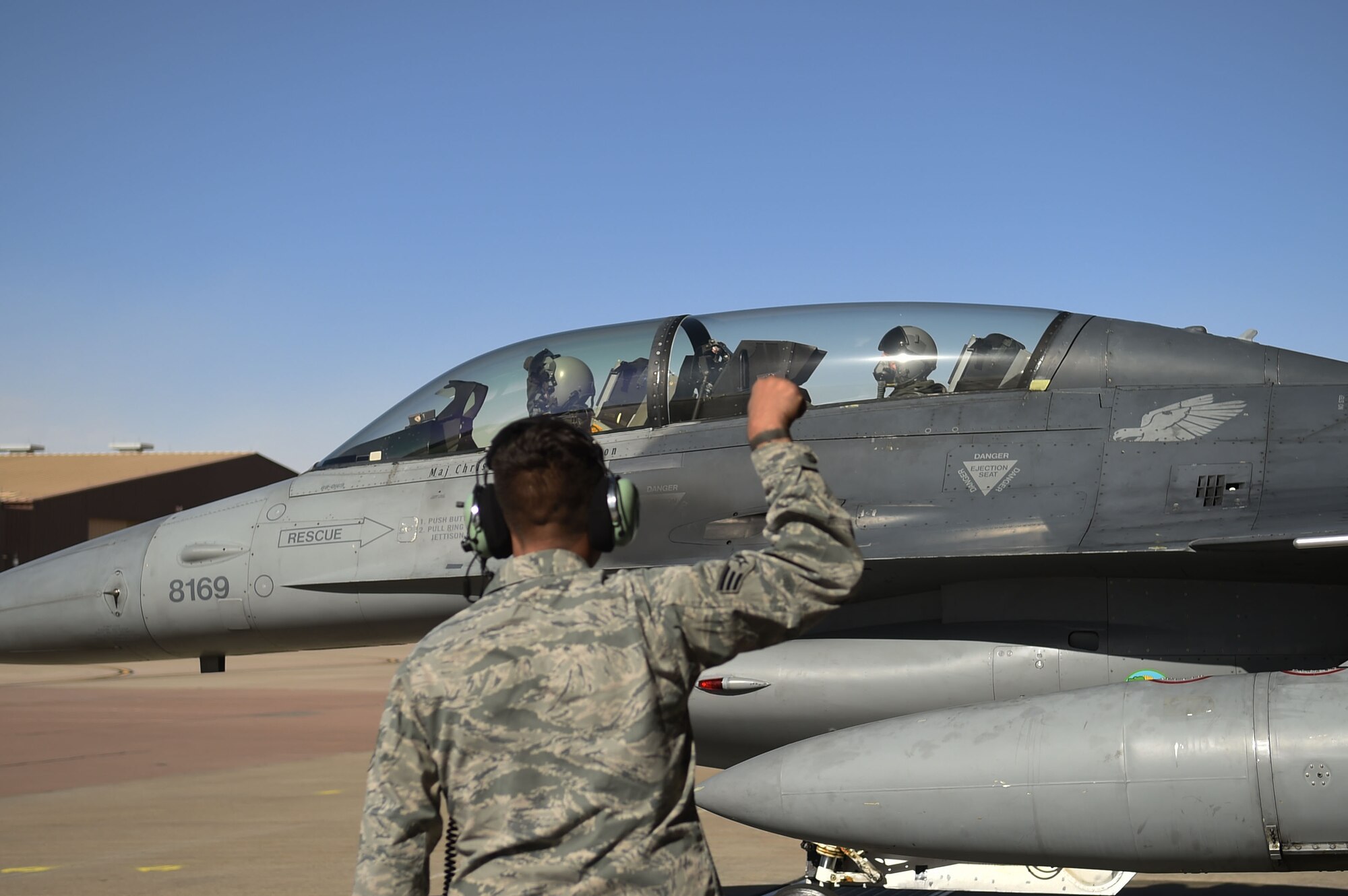 Senior Airman Joseph Garcia, 54th Aircraft Maintenance Squadron crew chief, gives the go sign for Maj. Matthew Marshall, 54th Fighter Group fighter pilot, and U.S. Rep. Steve Pearce, New Mexico 2nd district, for their flight, Dec. 16, 2016, Holloman Air Force Base, N.M. Pearce was offered an orientation flight on the F-16 Fighting Falcon, to better understand the capabilities and mission of the F-16. (U.S. Air Force photo by Tech. Sgt. Amanda N. Junk)