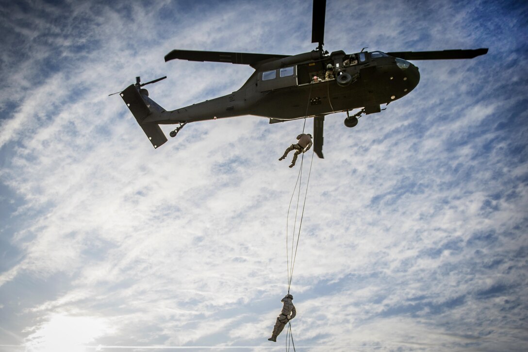 Airmen rappel from a UH-60 Black Hawk helicopter during annual rappelling refresher training in Tulsa, Okla., Dec. 14, 2016. The airmen are assigned to the Oklahoma Air National Guard’s 137th Security Forces Squadron and 138th Security Forces Squadron. Air National Guard photo by Tech. Sgt. Drew A. Egnoske