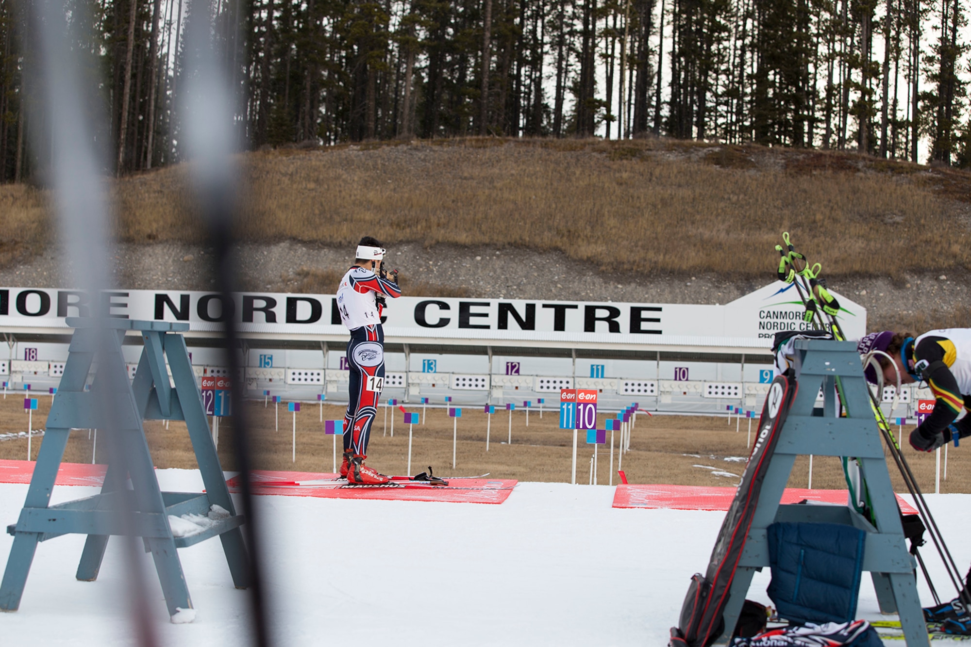 Alaska Guardsman Spc. Tahdg Nakada, a signal support specialist with Headquarters and Headquarters Company, 1st Battalion, 207th Aviation Regiment, zeros in his rifle before competing in the North American #1 and Calforex #1 Biathlon Cups at the Canmore Nordic Centre Provincial Park in Canmore, Alberta, Dec. 3, 2016. Nakada, 22, of Anchorage, placed 15th overall in both the men’s 10 km sprint and 15 km mass start during the two-day competition.