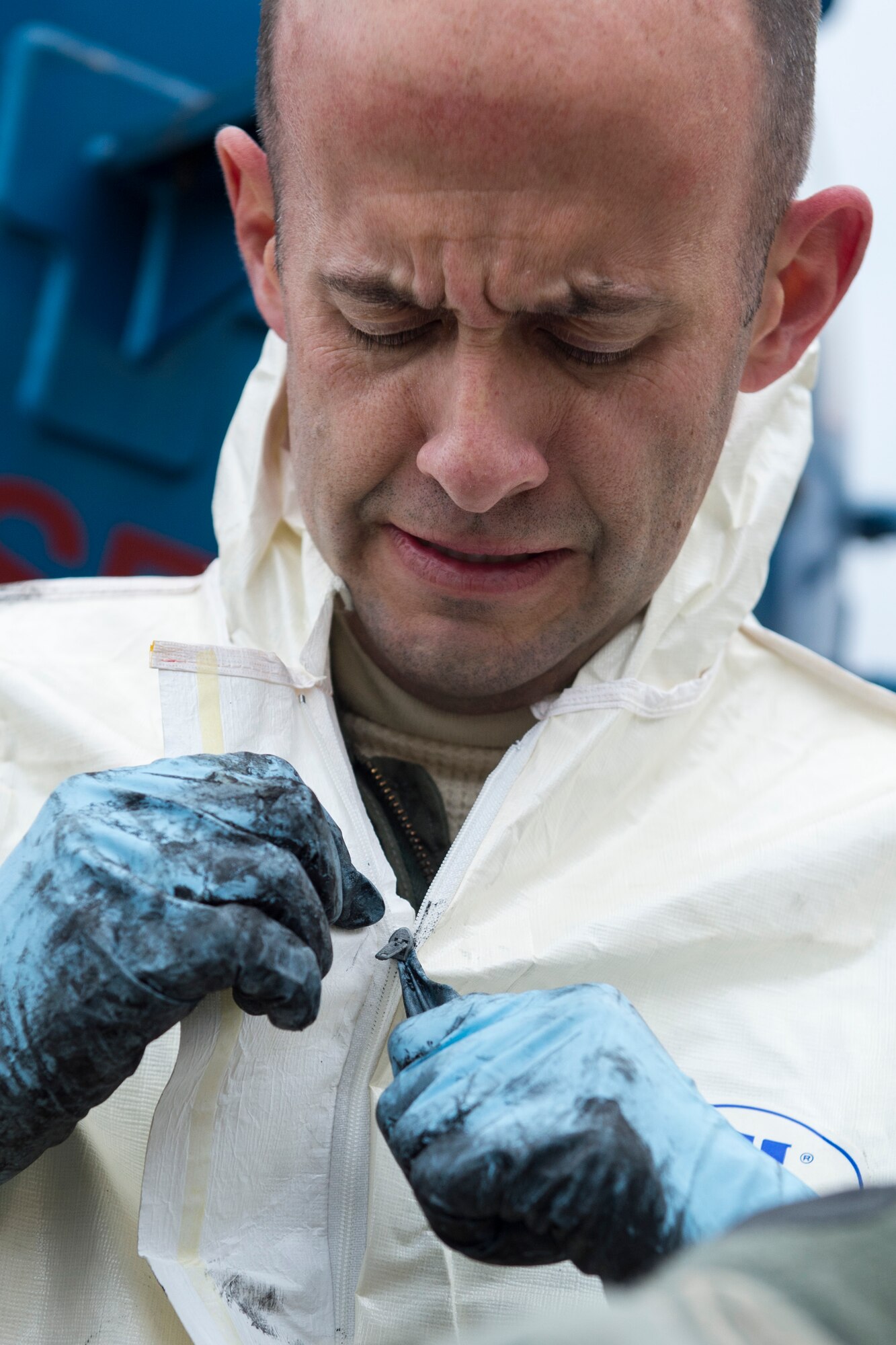 Col. E. John Teichert, 11th Wing and Joint Base Andrews commander, unzips his protective suit after getting out of a sewage containment hole at Joint Base Andrews, Md., Dec. 13, 2016. Teichert wanted to experience some of what the 11th Civil Engineer Squadron water and fuel system maintenance members do day-to-day. (U.S. Air Force photo by Senior Airman Philip Bryant)