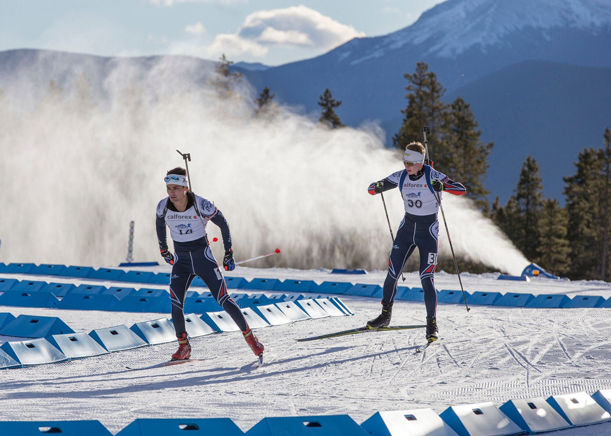 Alaska Guardsmen Spc. Tahdg Nakada, left, a signal support specialist with Headquarters and Headquarters Company, 1st Battalion, 207th Aviation Regiment, and his teammate, Pfc. Travis Cooper, a construction equipment mechanic with the 207th Engineer Utility Detachment, compete in the North American #1 and Calforex #1 Biathlon Cups at the Canmore Nordic Centre Provincial Park in Canmore, Alberta, Dec. 3, 2016. Nakada placed 15th overall in both the men’s 10 km sprint and 15 km mass start and Cooper took 1st in the Junior men’s 10 km sprint and the 12.5 km mass start during the two-day competition. (U.S. Army National Guard photo by Staff Sgt. Balinda O’Neal Dresel)