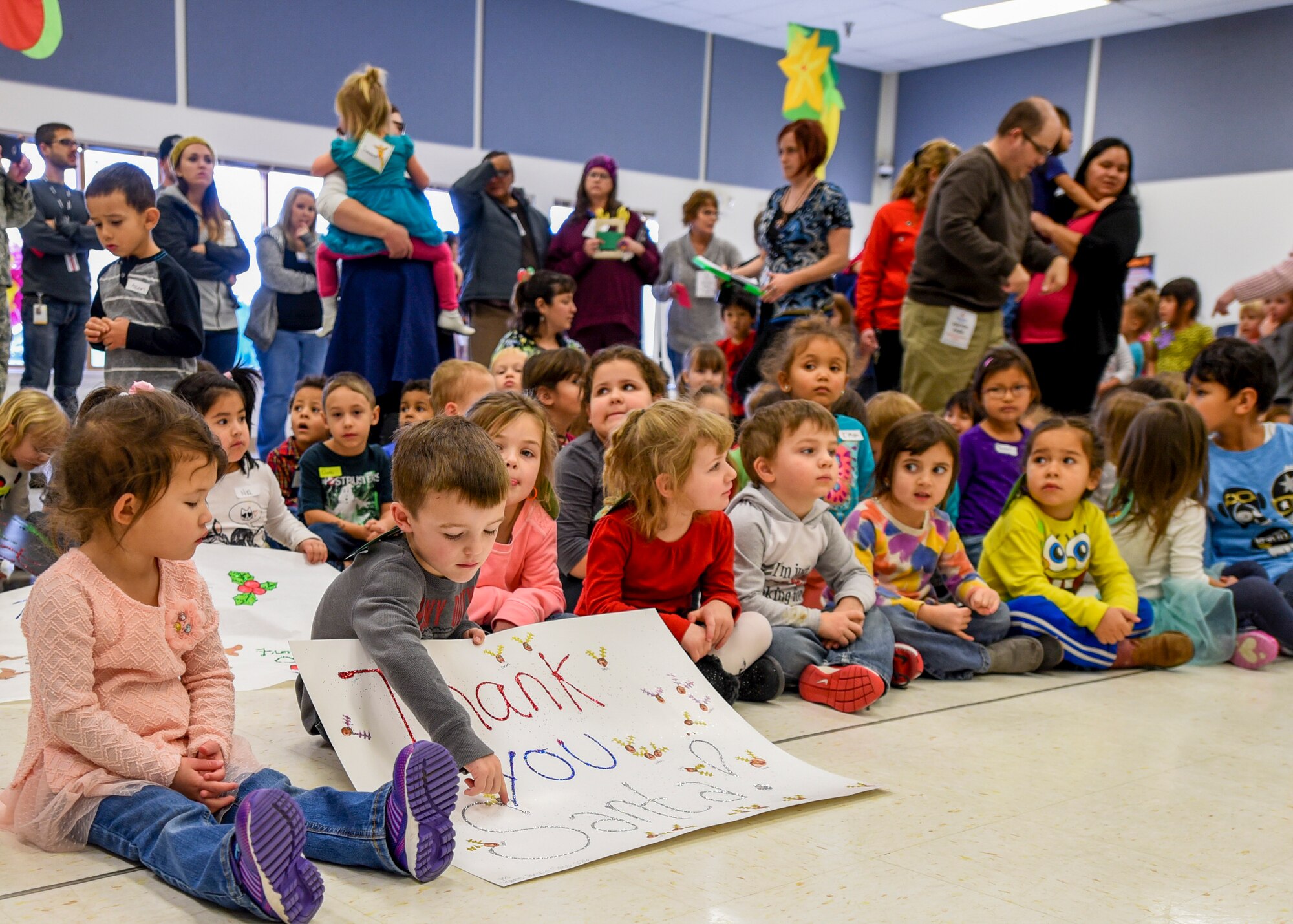 Children anxiously await the arrival of Santa Clause inside the Youth & Family Services center in Rapid City, S.D., Dec. 14, 2016. Angel Tree volunteers from the 28th Operations Group and the U.S. Postal Service provided more than 250 gifts for children enrolled in Y&FS. (U.S. Air Force photo by Airman 1st Class Randahl J. Jenson)