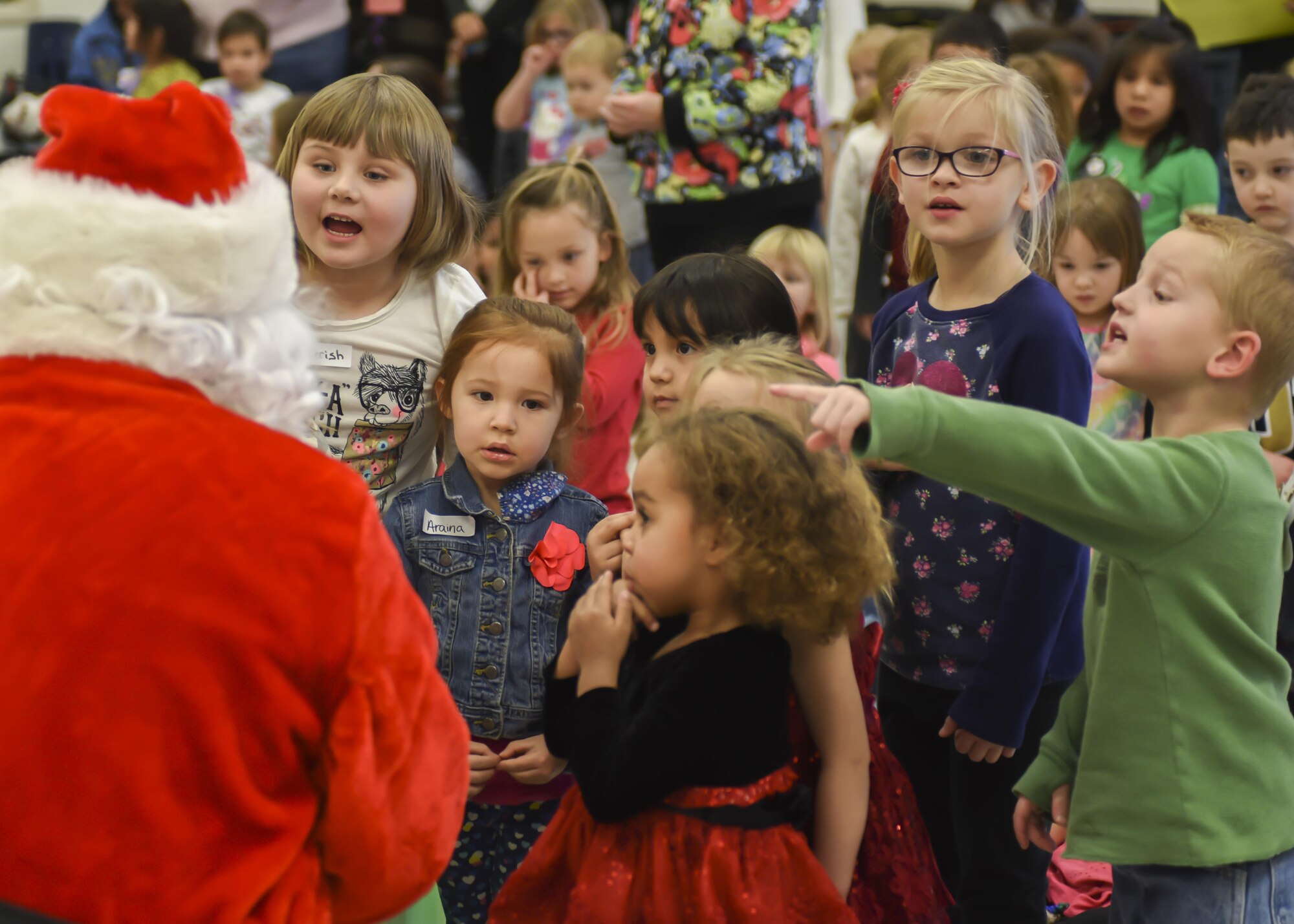 Children ask Santa questions inside the Youth & Family Services center in Rapid City, S.D., Dec. 14, 2016. After Santa made his official appearance, he visited individual classrooms to personally deliver a present to every child there. (U.S. Air Force photo by Airman 1st Class Randahl J. Jenson)