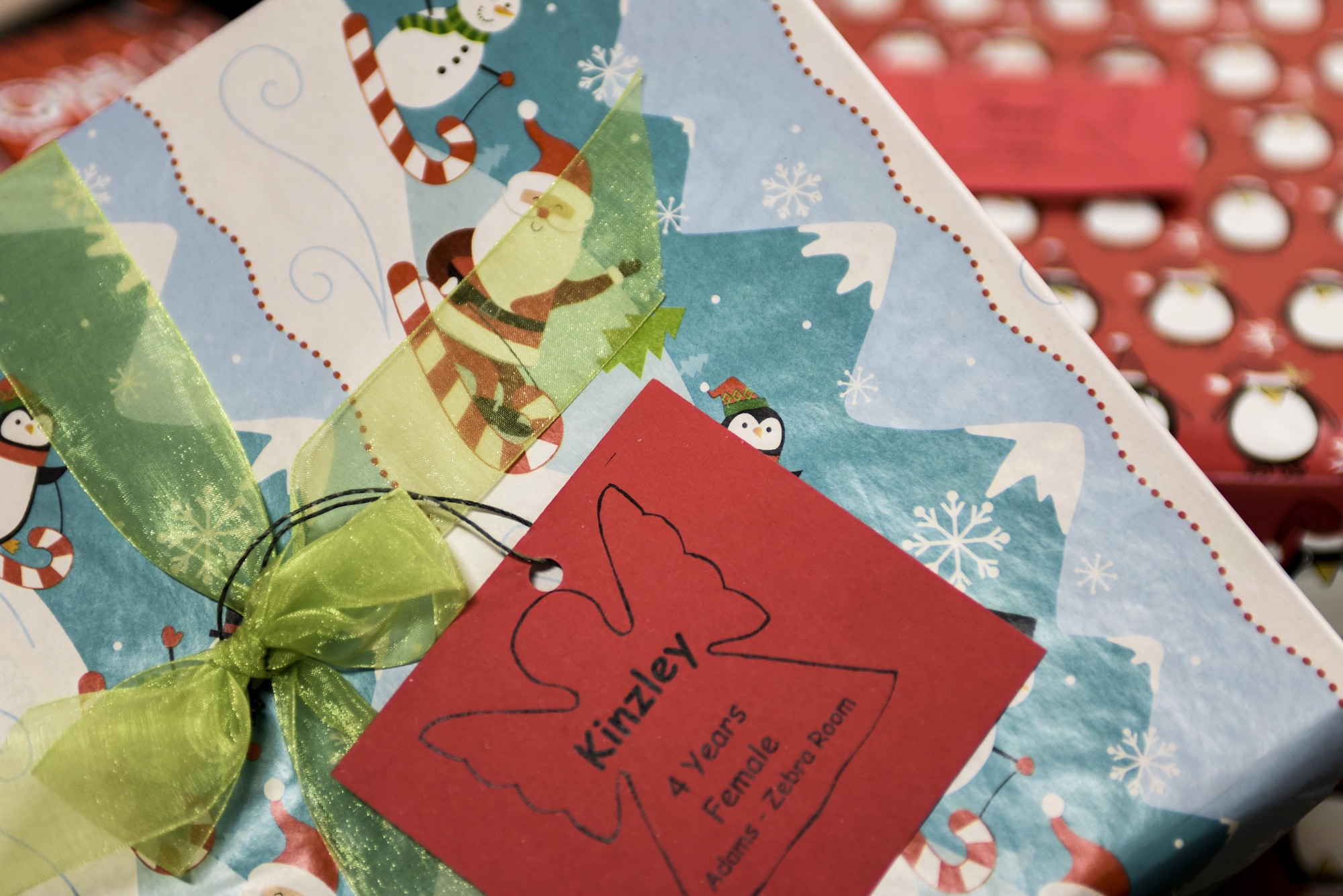 A gift sits in a pile before being hand-delivered to a child from Santa inside the Youth & Family Services center in Rapid City, S.D., Dec. 14, 2016. As part of their 10th annual Angel Tree program, Airmen from the 28th Operations Group and volunteers from the U.S. Postal Service donated more than 250 gifts to children in Rapid City. (U.S. Air Force photo by Airman 1st Class Randahl J. Jenson)