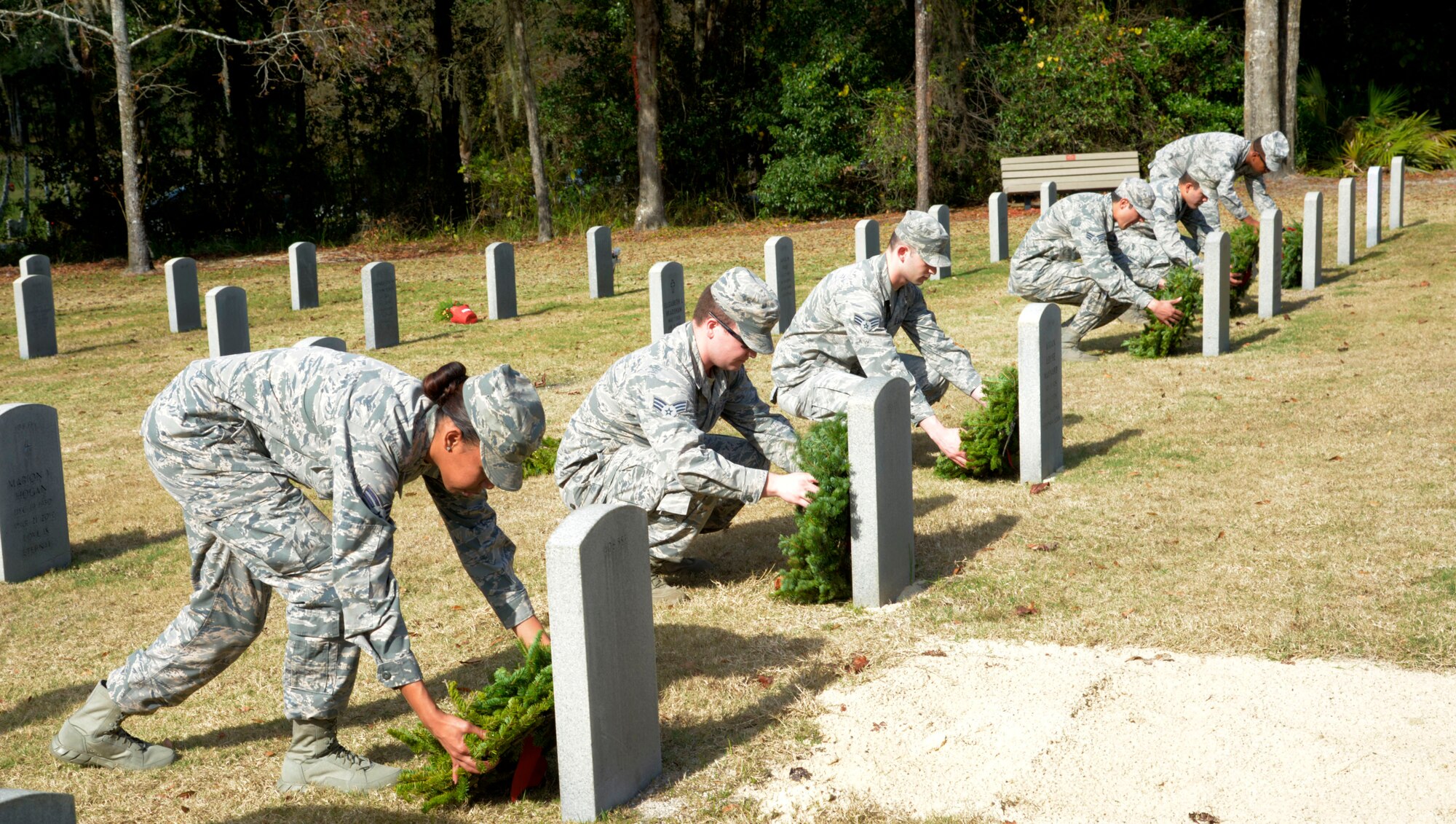 Airmen from MacDill Air Force Base,  lay wreaths on graves at the Florida National Cemetery in Bushnell, Fla., Dec. 17, 2016. Wreaths Across America is an organization that honors fallen service members by placing wreaths on gravesites during the holiday season. (U.S. Air Force photo by Senior Airman Tori Schultz)
