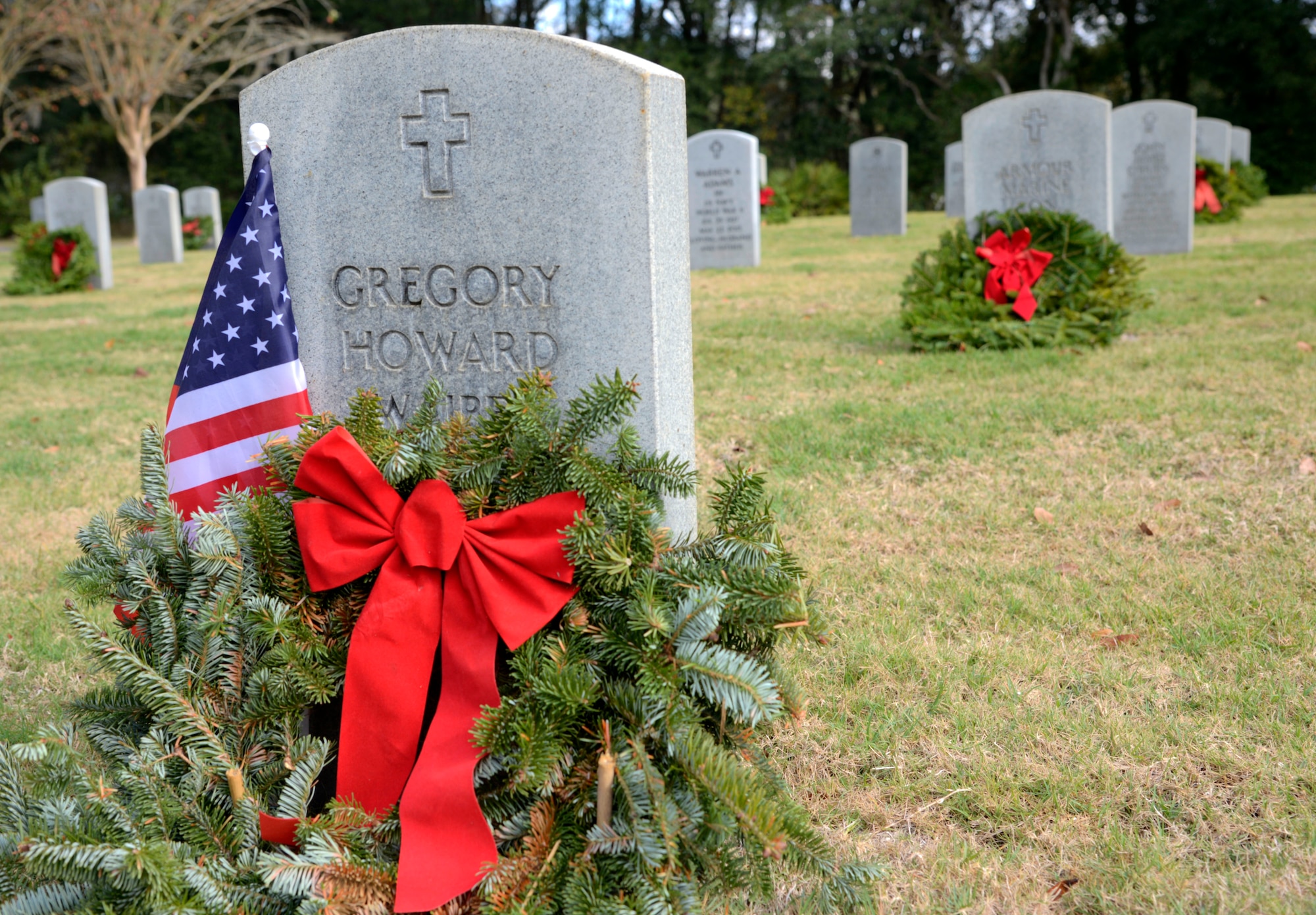 A wreath and American flag lie at the grave of Army Sgt. Gregory Waibel, Vietnam veteran, at Florida National Cemetery in Bushnell, Fla., Dec. 17, 2016. Wreaths Across America honors the men and women who served by placing wreaths at cemeteries worldwide every year. (U.S. Air Force photo by Senior Airman Tori Schultz)