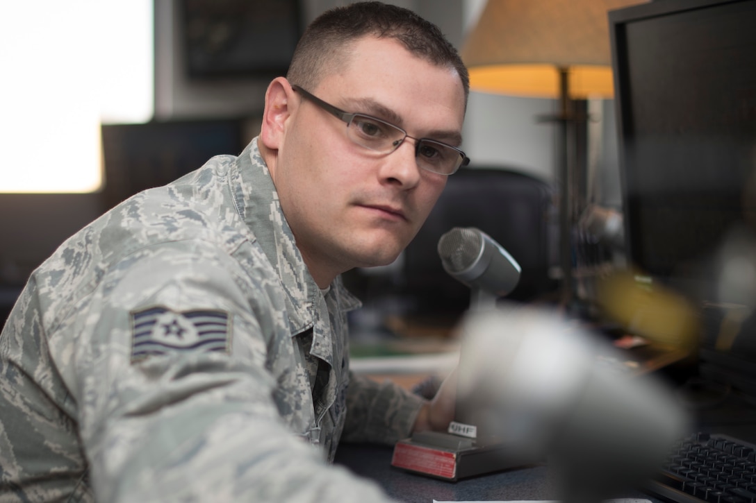 Tech. Sgt. Jake Wireman, 1st Helicopter Squadron NCO in charge of console operations, relays information to a UH-1N Iroquois aircrew at Joint Base Andrews, Md., Dec. 7, 2016. Wireman is a member of the nine-person mission control team awarded the 2015 Small Unit Command Post of the Year. The team follows flights and relays critical information to aircrews to complete their mission.  (U.S. Air Force photo by Airman 1st Class Rustie Kramer)