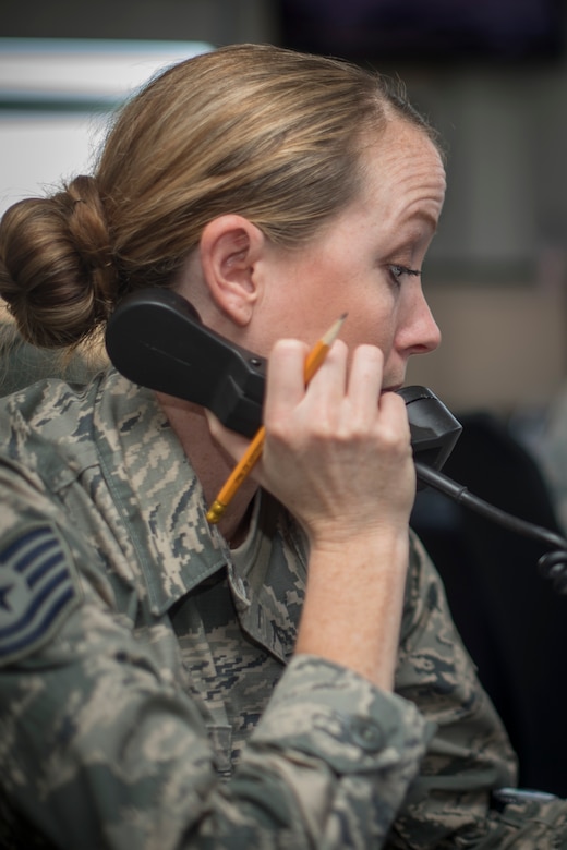 Tech. Sgt. Angeline Mahoney, 1st Helicopter Squadron support flight chief and mission controller, responds to the aircrew of a UH-1N Iroquois in flight at Joint Base Andrews, Md., Dec. 7, 2015. A team of nine Airmen comprises the 1st HS mission control following flights and relaying critical information to aircrews to complete their mission. The team was awarded the 2015 Small Unit Command Post of the Year based on excellence in mission accomplishment, performance and recognition of command post controllers, and training recognition. (U.S. Air Force photo by Airman 1st Class Rustie Kramer)