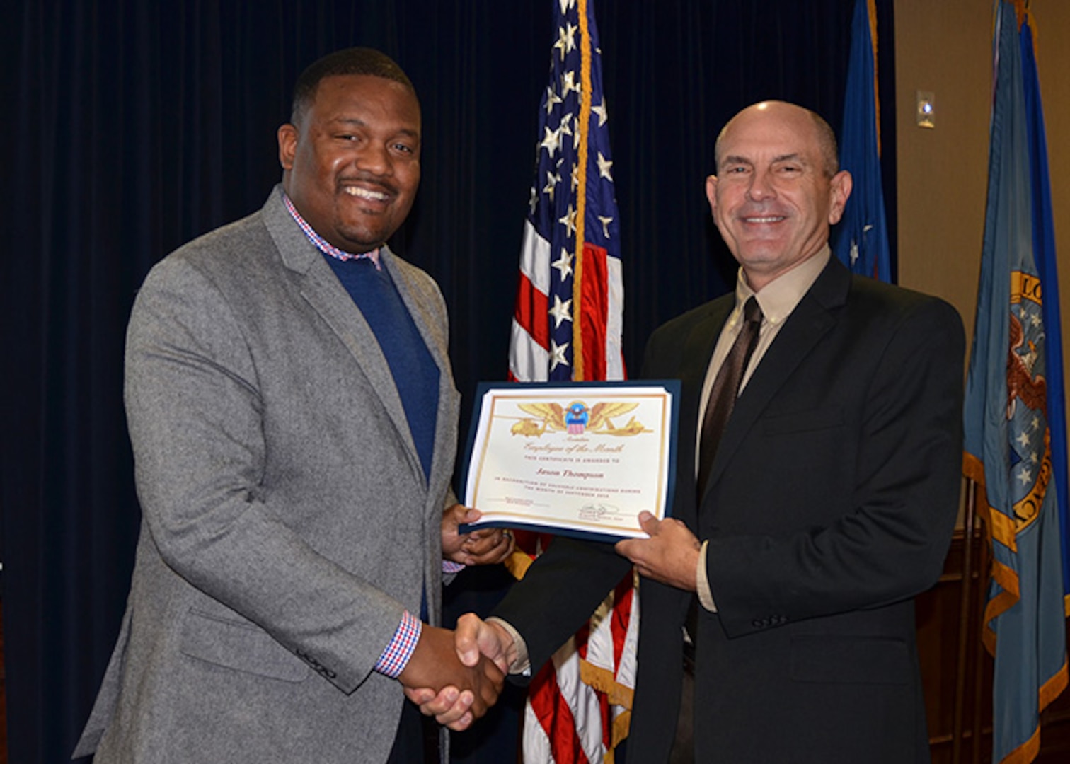 Defense Logistics Agency Aviation employee Jason Thompson receives certificate honoring his selection as the September 2016 Employee of the Month from DLA Aviation Deputy Commander Charlie Lillie Dec. 15, 2016 in a ceremony held in Richmond, Virginia. Thompson is a procurement analyst in the Procurement Process Support Directorate.