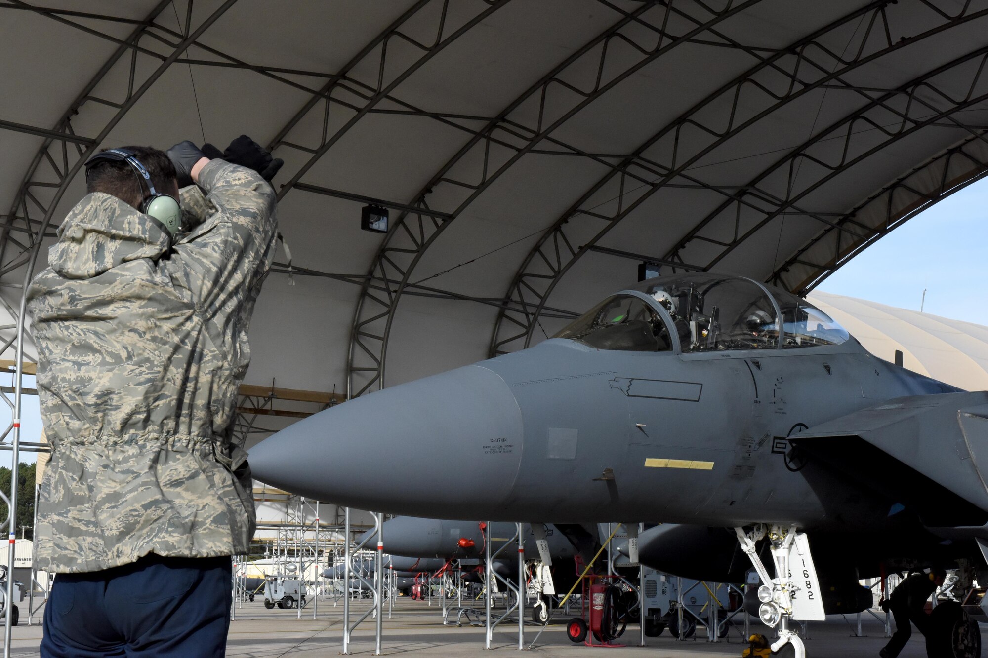 Airman 1st Class Nathan McDonald, 4th Aircraft Maintenance Squadron crew chief, marshals an F-15E Strike Eagle to participate in Razor Talon, Dec. 16, 2016, at Seymour Johnson Air Force Base, North Carolina. Razor Talon is an initiative developed by Seymour Johnson AFB to allow joint integration and training opportunities for every branch of the armed forces. (U.S. Air Force photo by Airman Miranda A. Loera)