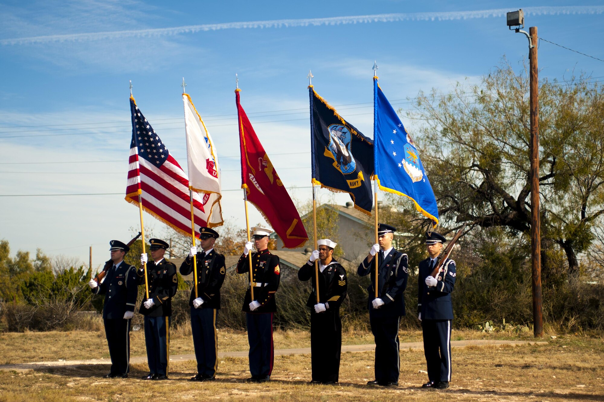 Goodfellow Air Force Base color guard stands ready for the playing of the National Anthem for Wreaths Across America at Belvedere Cemetery, San Angelo, Texas, Dec. 17, 2016. Every December, Wreaths Across America begins in the Arlington Cemetery and travels across the nation, laying wreaths at veteran cemeteries. (U.S. Air Force photo by Senior Airman Scott Jackson/released)