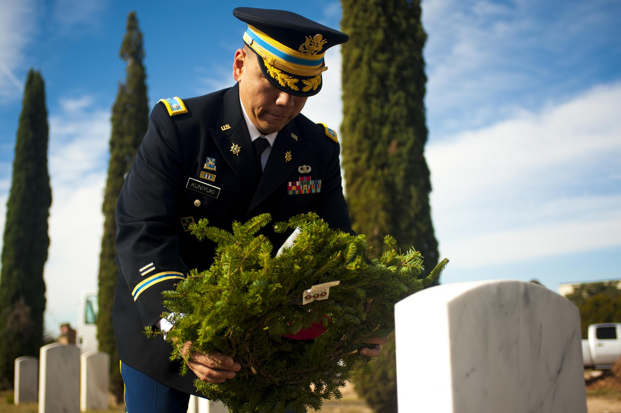 U.S. Army Lt. Col. Yukio Kuniyuki, 344th Military Intelligence Battalion commander, lays a wreath upon a veteran’s grave during a Wreaths Across America ceremony at Belvedere Cemetery, San Angelo, Texas, Dec. 17, 2016. Wreaths Across America’s mission is remember, honor, teach; remember the fallen, honor those who serve and teach our children the value of freedom. (U.S. Air Force photo by Senior Airman Scott Jackson/released)