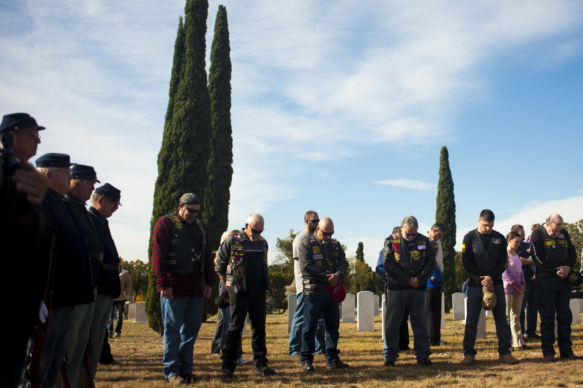 Forth Concho volunteers, Combat Vets Association members and San Angelo members bow their heads during the invocation for Wreaths Across America at Belvedere Cemetery, San Angelo, Texas, Dec. 17, 2016. The ceremony was to honor and give thanks to all deceased veterans. (U.S. Air Force photo by Senior Airman Scott Jackson/released)