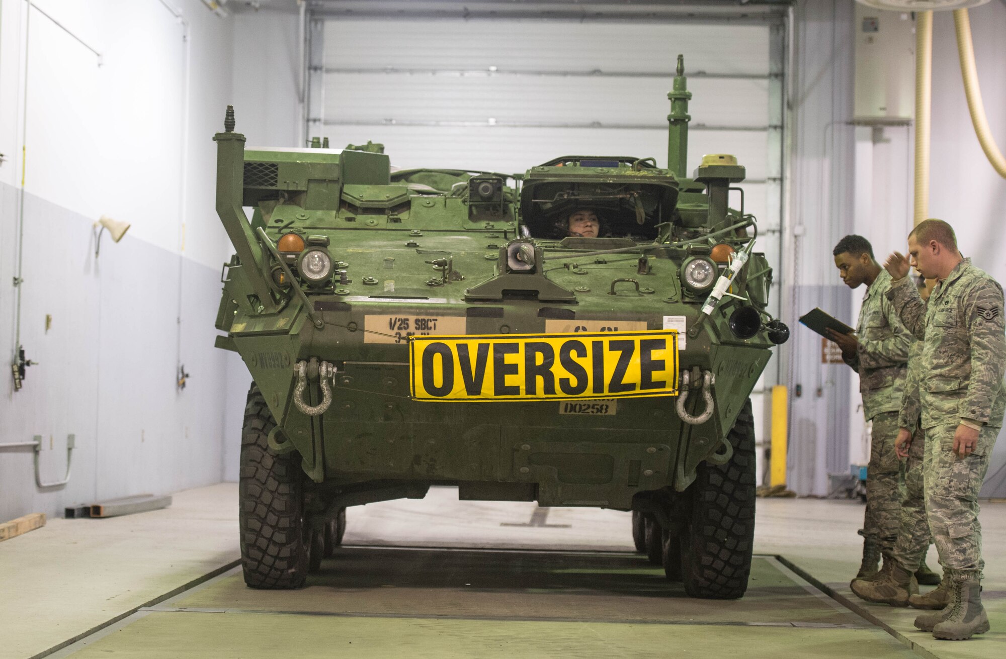 Airmen from the 821st Contingency Response Squadron prepare to perform a joint inspection on a Stryker armored vehicle from Fort Wainwright, Alaska, before being loaded onto a C-17 Globemaster III, Dec. 11, 2016, at Eielson Air Force Base, Alaska. A contingency response team was sent to Eielson AFB to support the Army’s Rapid Alaska Airlift Week exercise. (U.S. Air Force photo by Staff Sgt. Robert Hicks)