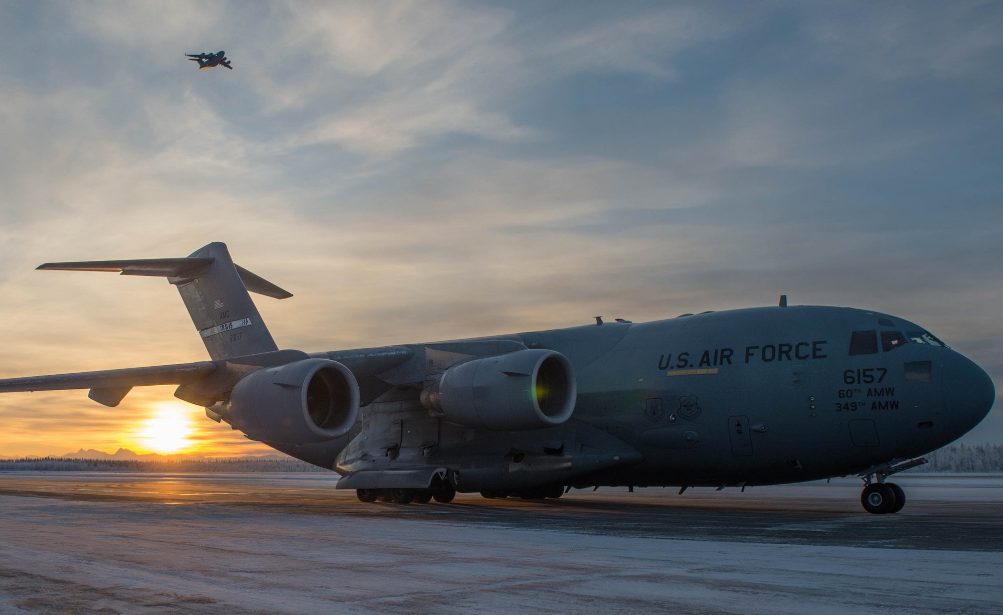 A C-17 Globemaster III aircraft from Travis Air Force Base, California, is parked on the runway before being loaded with two Stryker armored vehicles Dec. 13, 2016, at Eielson Air Force Base, Alaska. A contingency response team was sent to Eielson AFB to support the Army’s Rapid Alaska Airlift Week exercise. (U.S. Air Force photo by Staff Sgt. Robert Hicks)