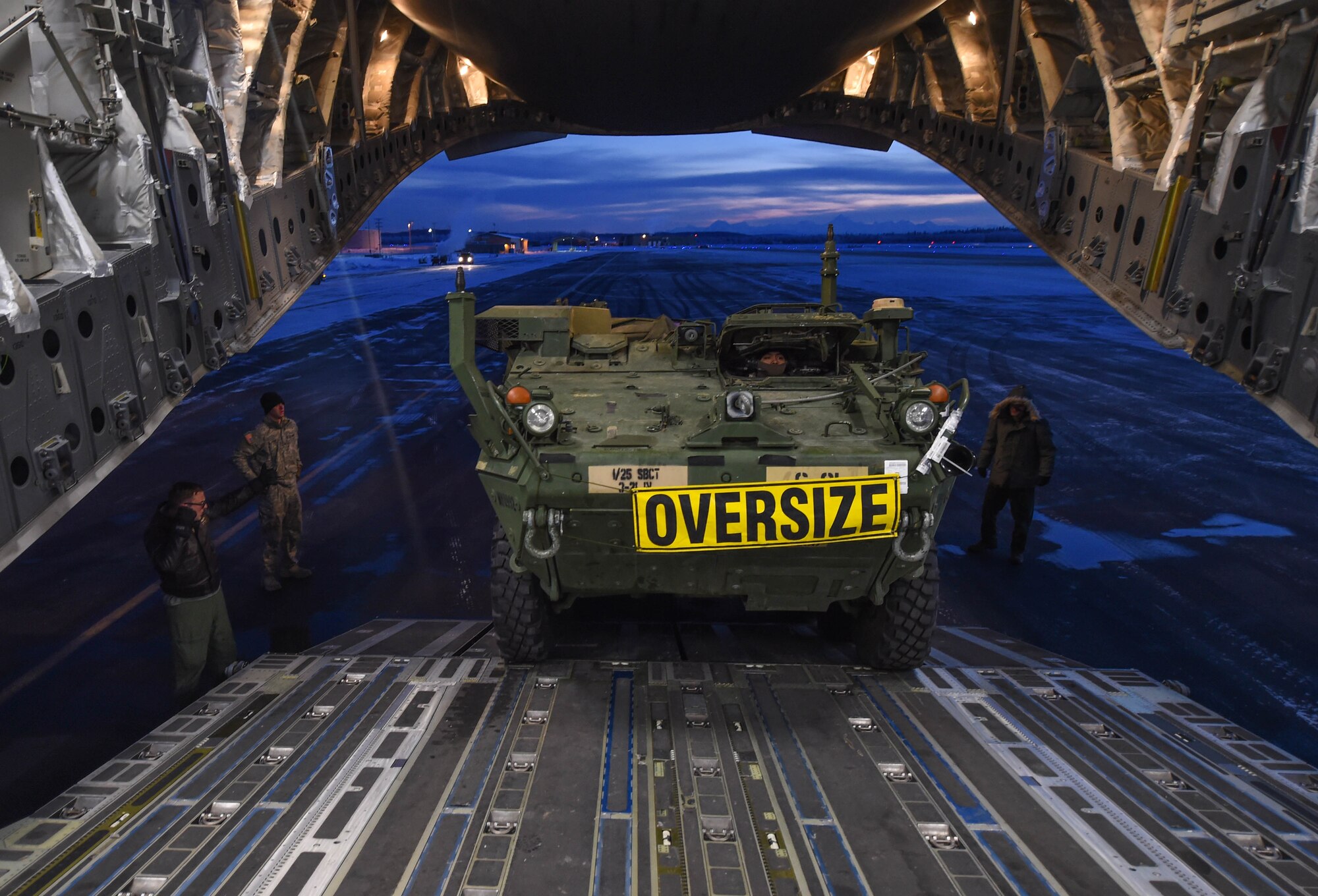 A Stryker armored vehicle from the 1st Battalion, 24th Infantry Regiment, 1st Stryker Brigade Combat Team, 25th Infantry Division, is loaded onto a C-17 Globemaster III aircraft, Dec.13, 2016, at Eielson Air Force Base, Alaska. A contingency response team was sent to Eielson AFB to support the Army’s Rapid Alaska Airlift Week exercise. (U.S. Air Force photo by Staff Sgt. Robert Hicks)