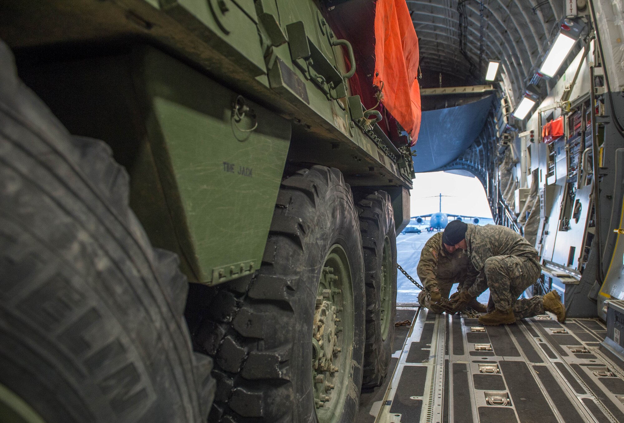 Soldiers from the 1st Battalion, 24th Infantry Regiment, 1st Stryker Brigade Combat Team, 25th Infantry Division, straps down a Stryker armored vehicle onto a C-17 Globemaster III aircraft before take-off, Dec. 13,2016, at Eielson Air Force Base, Alaska. A contingency response team was sent to Eielson AFB to support the Army’s Rapid Alaska Airlift Week exercise. (U.S. Air Force photo by Staff Sgt. Robert Hicks)