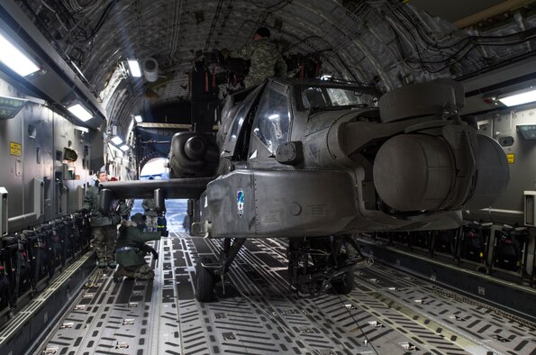 An AH-64 Apache helicopter from the 1st Attack Reconnaissance Battalion, 25th Combat Aviation Brigade sits in a C-17 Globemaster III Dec.14, 2016, at Eielson Air Force Base, Alaska. A contingency response team was sent to Eielson AFB to support the Army’s Rapid Alaska Airlift Week exercise. (U.S. Air Force photo/Staff Sgt. Robert Hicks)