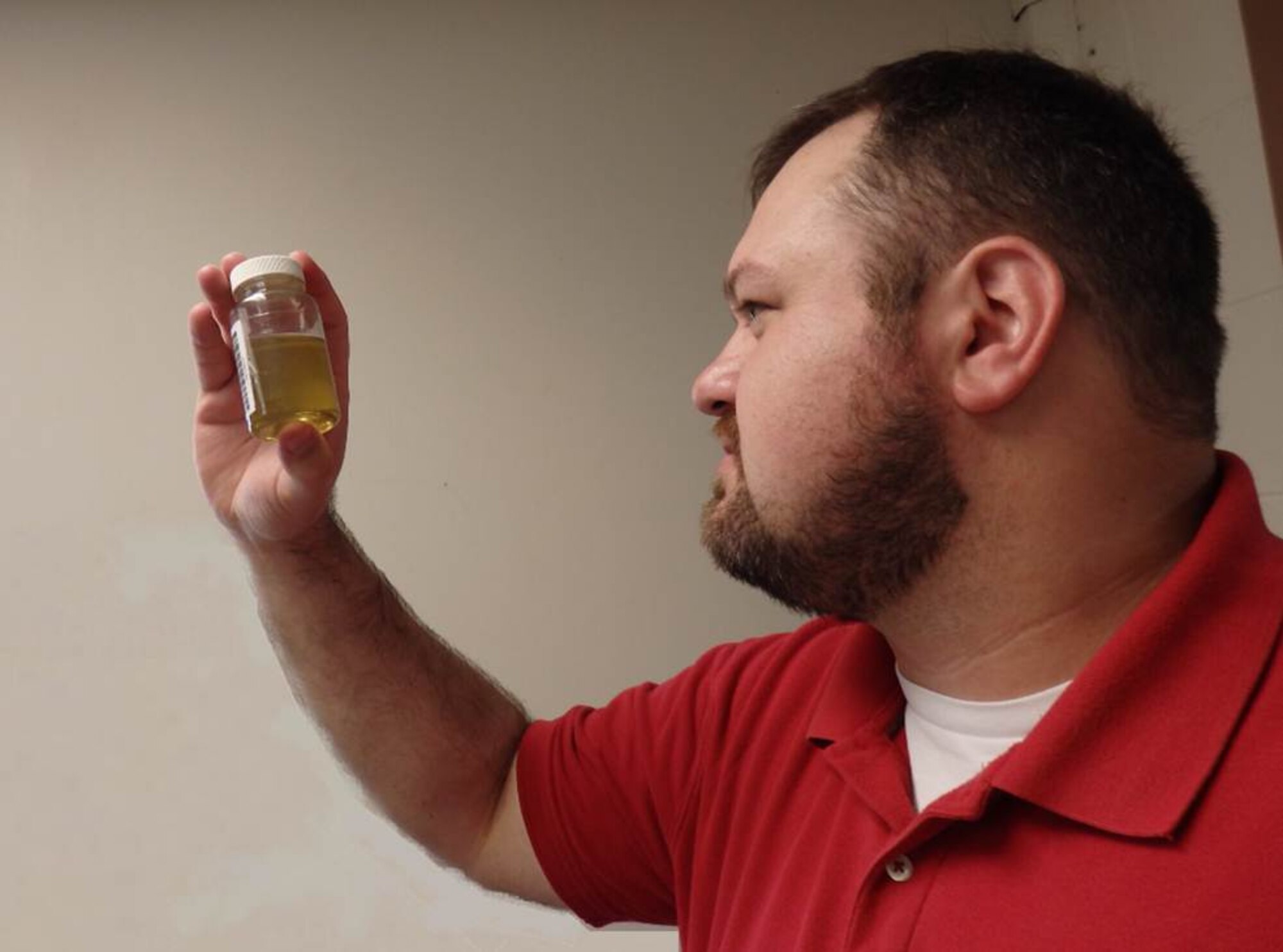 Casey Schewe, Oil Analysis/Processing Program lead, examines a sample of oil taken from a hydraulic unit. Preventative maintenance efforts like this are part of the Asset Health Assurance program at AEDC, which is a long-term reliability and maintenance program for the Test Operations and Sustainment contract. (AEDC photo)