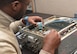 Airman 1st Class Terre Camille, an avionics technician assigned to the 28th Maintenance Squadron, installs an amp into a Line Replaceable Unit at Ellsworth Air Force Base, S.D., Dec. 6, 2016. An LRU is a modular component of complex electronic systems for aircraft that can be replaced quickly, and generally with a minimum of tools. (U.S. Air Force photo by Airman 1st Class Donald C. Knechtel)