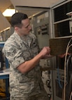 Senior Airman Dylan Slaughter, an avionics technician assigned to the 28th Maintenance Squadron, inserts a panel into a Radar Electronic Warfare (REW) station at Ellsworth Air Force Base, S.D., Dec. 6, 2016. The REW and the Defensive Avionics (DAV) stations are used to repair line replaceable units that affect aircraft systems such as radar, terrain following, counter measures and radios. (U.S. Air Force photo by Airman 1st Class Donald C. Knechtel)
