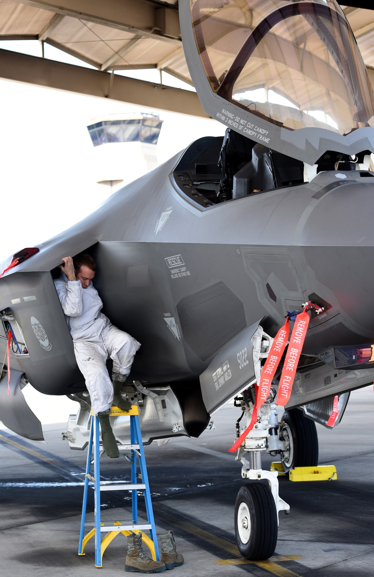 U.S. Air Force Senior Airman Zachary Weeks, 33d Aircraft Maintenance Squadron F-35A crew chief, exits an F-35A Lightning II intake after completing a post flight inspection during Checkered Flag 17-01, Dec. 8, 2016, at Tyndall Air Force Base, Florida. Checkered Flag facilitates integration between fifth and fourth-generation aircraft communities. These exercises are critical to hone the tactics techniques and procedures (TTP’s) for the aircraft’s inevitable deployment fighting alongside other combat assets. While the exercise is prime opportunity to learn about how we fly the aircraft, it presents the same learning opportunities for preventative and restorative maintenance. (U.S. Air Force photo by Staff Sgt. Peter Thompson)