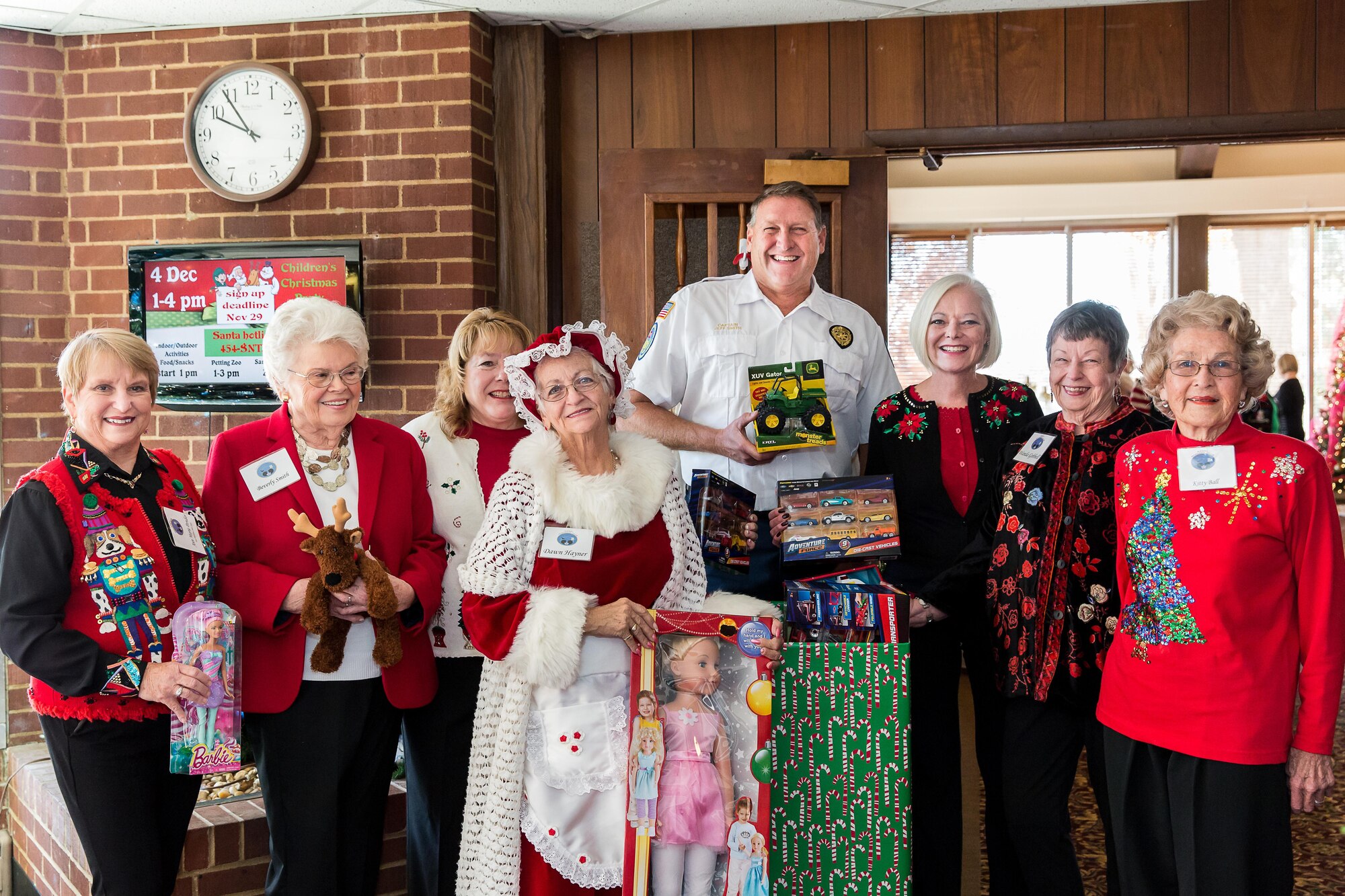 Capt. Jeff Smith (fifth from the left), with the Tullahoma Fire Department, collects gifts provided by the AEDC Woman’s Club for the Toys for Tots program. Also pictured is Anne-Marie Pender, Beverly Smith, Vicky Porter, Dawn Hayner, Suzette McCrorey, Wanda Gobbell and Kitty Ball. (Courtesy photo)