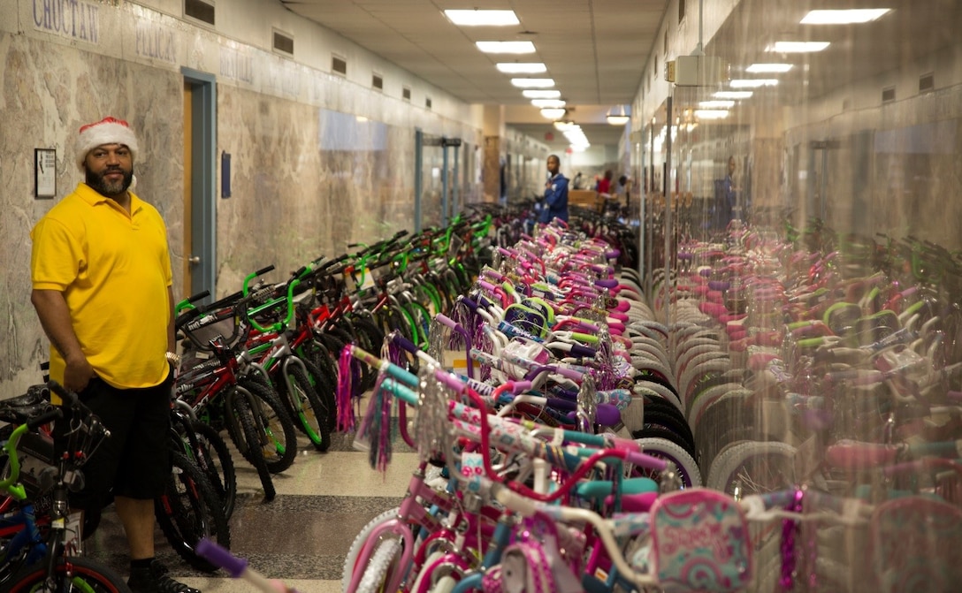 A Zulu crew member stands by to distribute approximately 700 bicycles lining the hallway of New Orleans City Hall during the Zulu Social Aid and Pleasure Club’s annual Toys for Tots toy distribution, Dec. 17, 2016. Nearly 2,000 families lined up to receive toys and gifts. Toys for Tots, an annual Marine Corps Reserve program, aims at collecting new, unwrapped Christmas gifts for less fortunate children in the community. Since its inception in 1947, Toys for Tots has distributed 512 million toys to 237 million children.