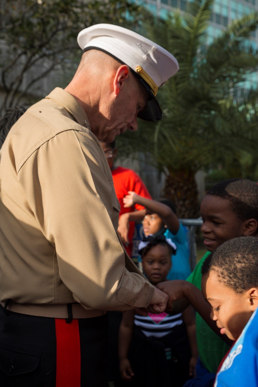 Lt. Gen. Rex C. McMillian, commander of Marine Forces Reserve and Marine Forces North, fist bumps a child who has been eagerly waiting to receive a bicycle at New Orleans City Hall during the Zulu Social Aid and Pleasure Club’s annual Toys for Tots distribution, Dec. 17, 2016. Nearly 2,000 families lined up to receive toys and gifts. Toys for Tots, an annual Marine Corps Reserve program, aims at collecting new, unwrapped Christmas gifts for less fortunate children in the community. Since its inception in 1947, Toys for Tots has distributed 512 million toys to 237 million children.