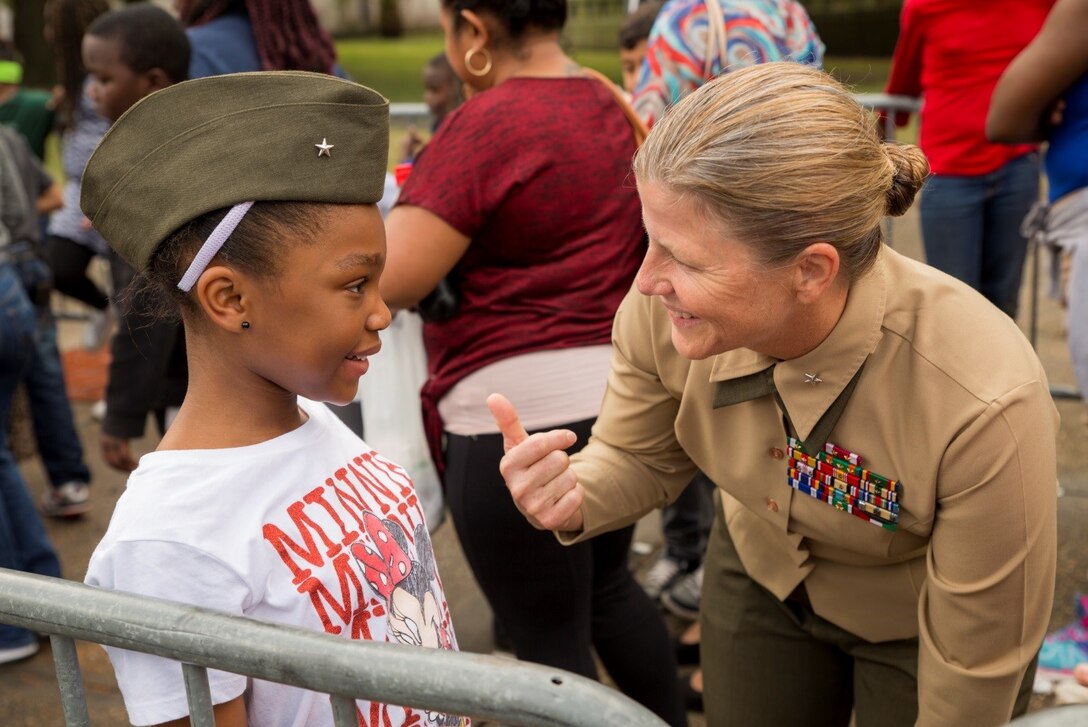 Brig. Gen. Helen G. Pratt, commanding general of 4th Marine Logistics Group, lets a child try on her cover and talks to her about what it’s like to be a Marine during the Zulu Social Aid and Pleasure Club’s annual Toys for Tots distribution at New Orleans City Hall, Dec. 16, 2017. Nearly 2,000 families lined up to receive toys and gifts. Toys for Tots, an annual Marine Corps Reserve program, aims at collecting new, unwrapped Christmas gifts for less fortunate children in the community. Since its inception in 1947, Toys for Tots has distributed 512 million toys to 237 million children.