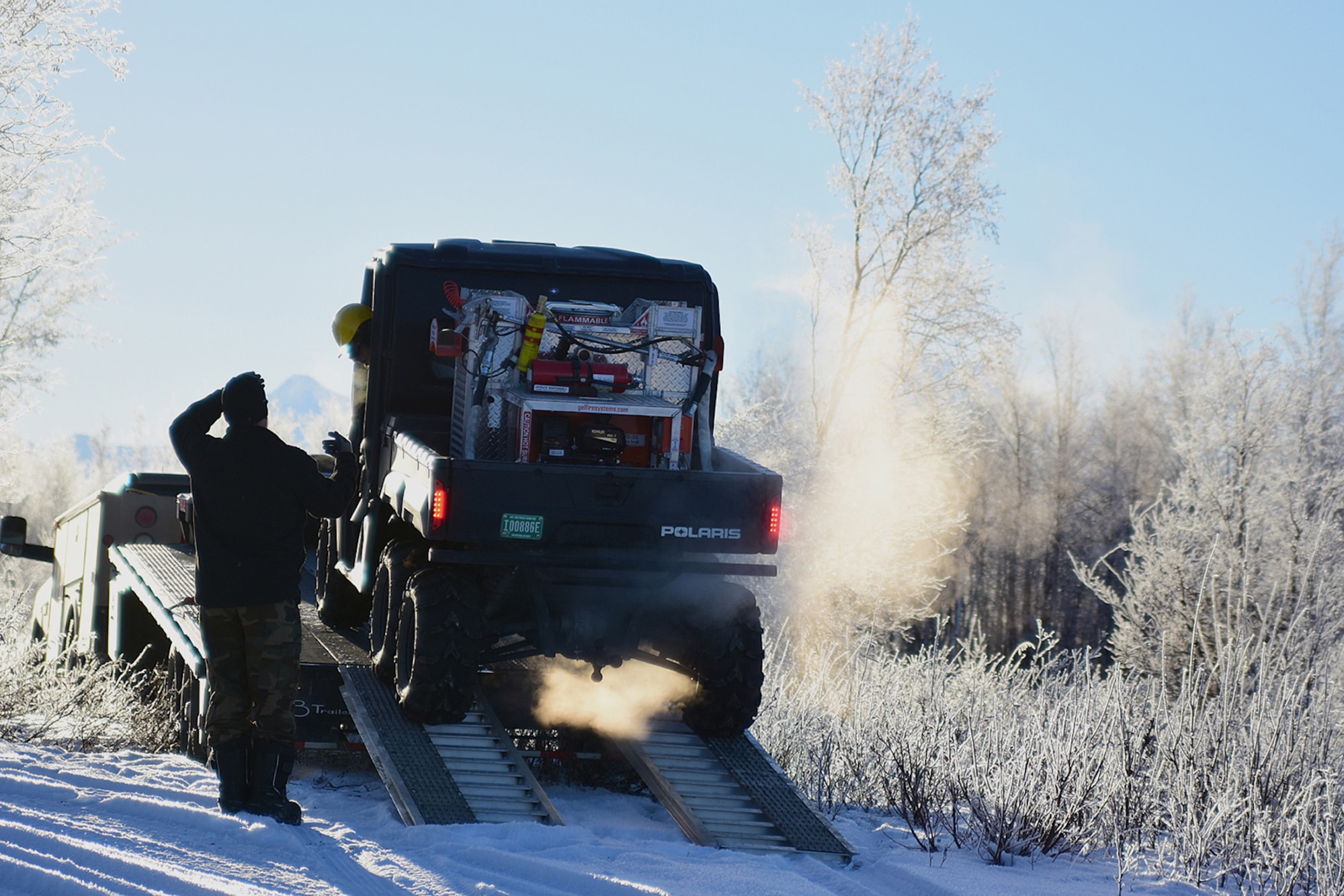 Specialists from the Bureau of Land Management Alaska Fire Service unload the all-terrain vehicle which carries the Terra Torch – the tool they will use to make short work of brush piles as part of a prescribed burn project in U.S. Army Alaska’s Donnelly Training Area near Fort Greely Nov. 4, 2016. The piles were created by U.S. Army Alaska hand crews working to remove dead and decaying vegetation and black spruce in an effort to reduce the chances of a wildfire on military lands. AFS provides wildland fire management for 1.6 million acres of military withdrawn public land under an interagency service agreement with U.S. Army Alaska. (Army photo/John Pennell)