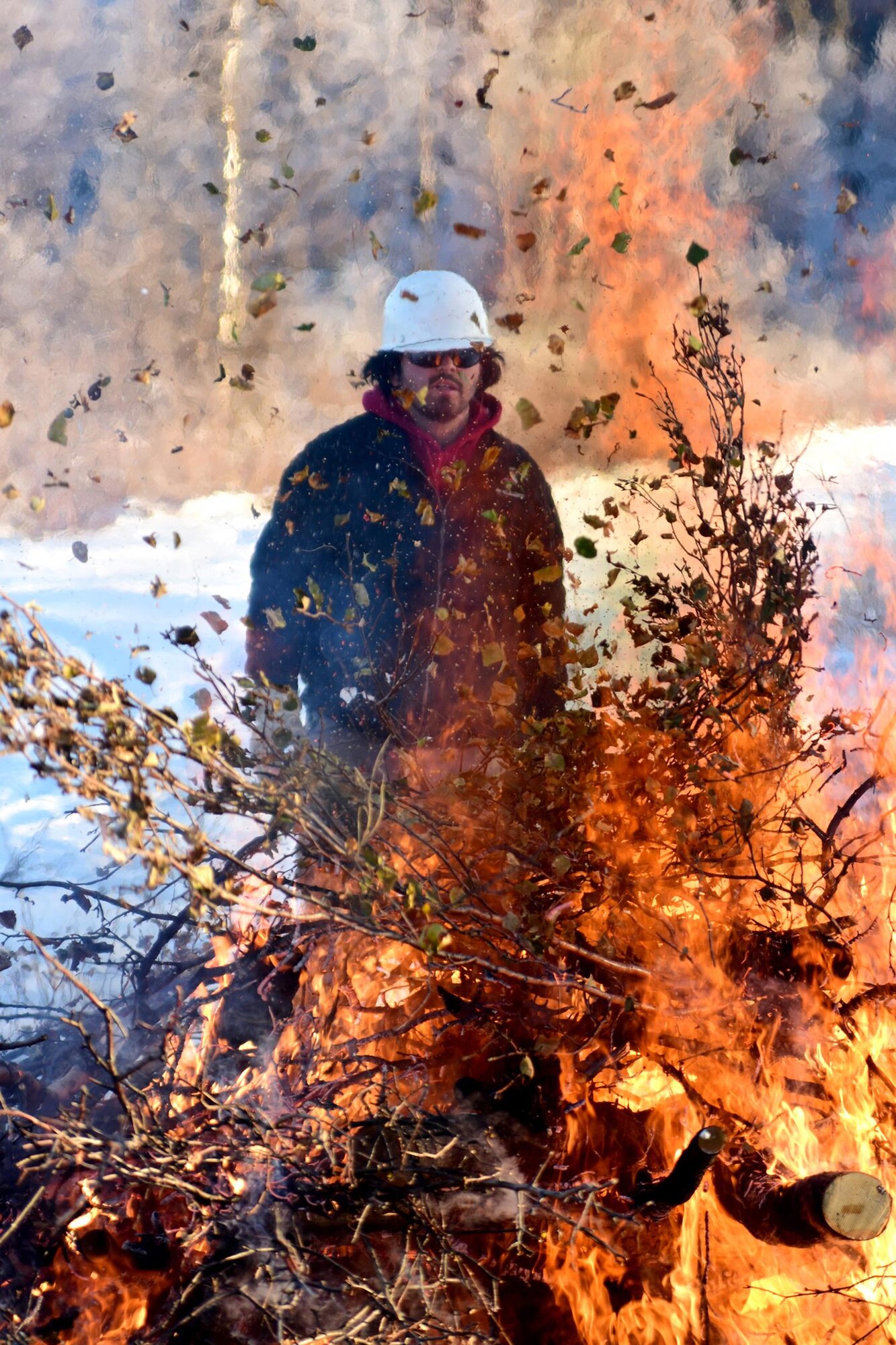 Bureau of Land Management Bureau of Land Management Alaska Fire Service specialist Brian Pitts monitors burning piles of brush as part of a prescribed burn project in U.S. Army Alaska’s Donnelly Training Area near Fort Greely Nov. 4, 2016. The piles were created by U.S. Army Alaska hand crews working to remove dead and decaying vegetation and black spruce in an effort to reduce the chances of a wildfire on military lands. AFS provides wildland fire management for 1.6 million acres of military withdrawn public land under an interagency service agreement with U.S. Army Alaska. (Army photo/John Pennell)