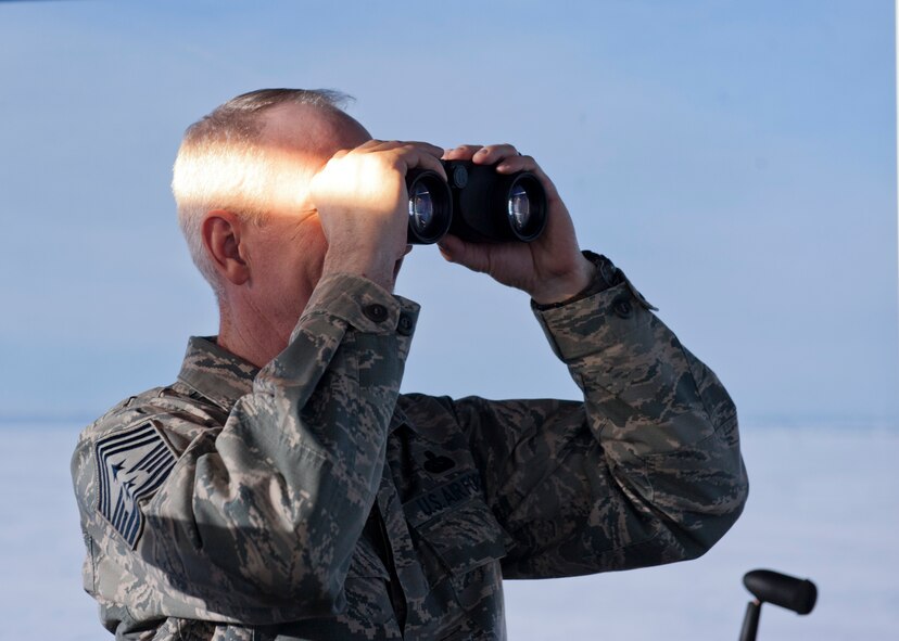Chief Master Sgt. Alan Boling, 8th Air Force command chief, looks through binoculars at Minot Air Force Base, N.D., Dec. 15, 2016. Boling toured Minot’s facilities, including the air traffic control tower and spoke with 5th Bomb Wing Airmen. (U.S. Air Force photo/Airman 1st Class J.T. Armstrong)