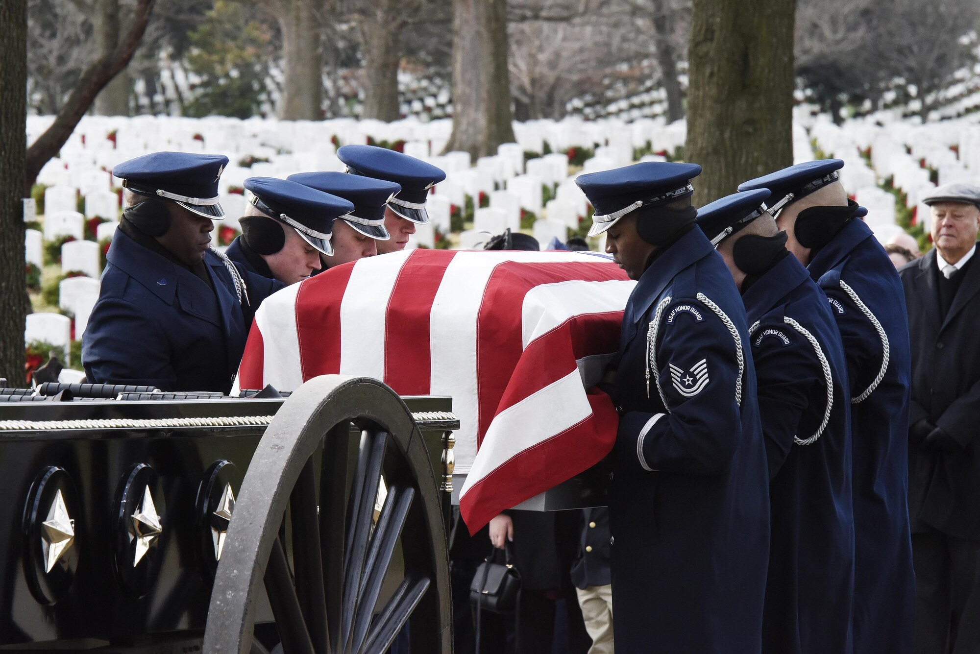 Members of the U.S. Air Force Honor Guard remove Maj. Troy Gilbert from a caisson during his interment at Arlington National Cemetery, Va., Dec. 19, 2016. Gilbert was killed Nov. 27, 2006, while flying a mission in direct support of coalition ground combat operations when his F-16C Fighting Falcon crashed approximately 20 miles northwest of Baghdad. (U.S. Air Force photo/Staff Sgt. Alyssa C. Gibson)