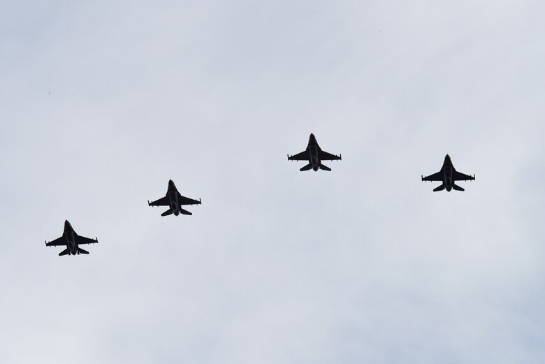 Four F-16 Fighting Falcons fly in formation over the funeral service for Maj. Troy Gilbert at Arlington National Cemetery, Va., Dec. 19, 2016. The aircraft are stationed at Luke Air Force Base, Ariz., which was Gilbert’s home station at the time of his death. (U.S. Air Force photo/Staff Sgt. Alyssa C. Gibson) 