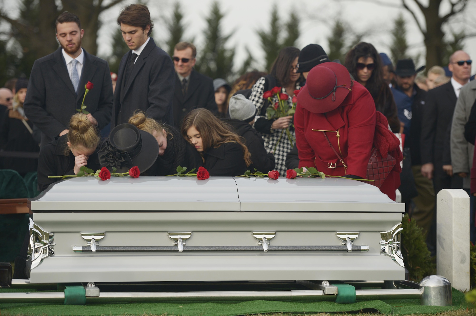 Maj. Troy Gilbert’s family places roses on his casket during his interment at Arlington National Cemetery, Va., Dec. 19, 2016. Gilbert was killed Nov. 27, 2006, while flying a mission in direct support of coalition ground combat operations when his F-16C Fighting Falcon crashed approximately 20 miles northwest of Baghdad. This was the third interment for the Airman at Arlington since 2006, and reunited remains recovered this year with partial remains originally recovered in 2006 and 2012. (U.S. Air Force photo/ Tech. Sgt. Joshua DeMotts)