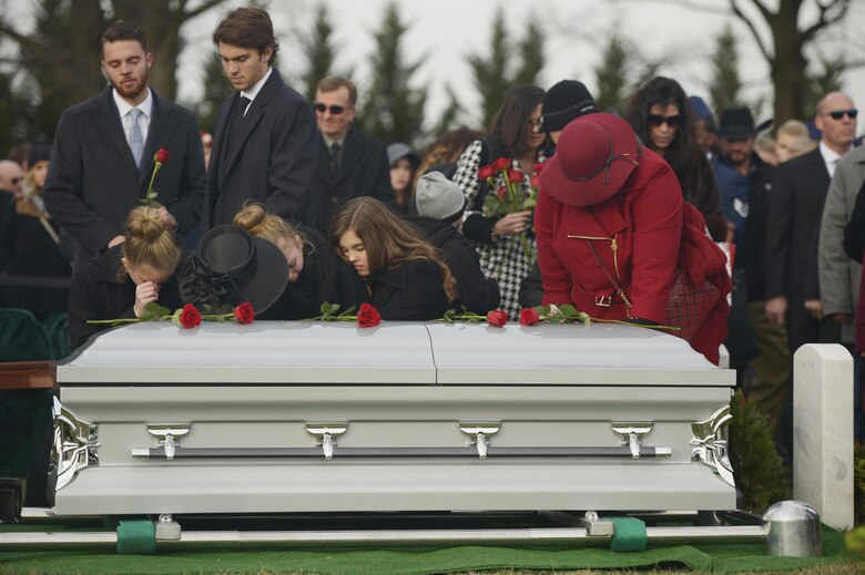 Maj. Troy Gilbert’s family places roses on his casket during his interment at Arlington National Cemetery, Va., Dec. 19, 2016. Gilbert was killed Nov. 27, 2006, while flying a mission in direct support of coalition ground combat operations when his F-16C Fighting Falcon crashed approximately 20 miles northwest of Baghdad. This was the third interment for the Airman at Arlington since 2006, and reunited remains recovered this year with partial remains originally recovered in 2006 and 2012. (U.S. Air Force photo/ Tech. Sgt. Joshua DeMotts)