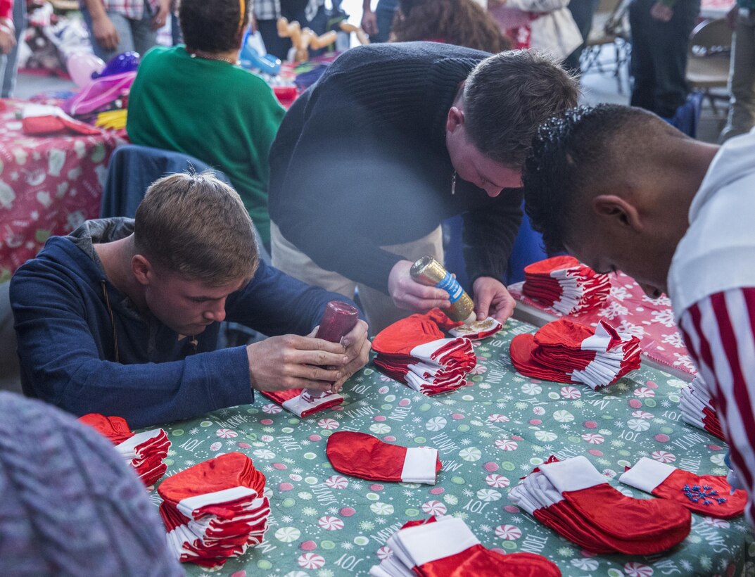 U.S. Marines with I Marine Expeditionary Force Headquarters Group design holiday stockings during the I MHG Holiday Party at Marine Corps Base Camp Pendleton, Calif., Dec. 14, 2016. The Marines and their family members celebrated the holiday season by building gingerbread houses, decorating stockings and designing Christmas ornaments while enjoying a holiday meal in camaraderie. (U.S. Marine Corps photo by Cpl. Alvin Pujols)