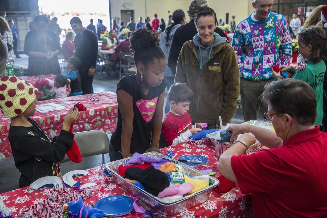 U.S. Marines and their family members decorate sock puppets during the I Marine Expeditionary Force Headquarters Group Holiday Party at Marine Corps Base Camp Pendleton, Calif., Dec. 14, 2016. The Marines and their family members celebrated the holiday season by building gingerbread houses, decorating stockings and designing Christmas ornaments while enjoying a holiday meal in camaraderie. (U.S. Marine Corps photo by Cpl. Alvin Pujols