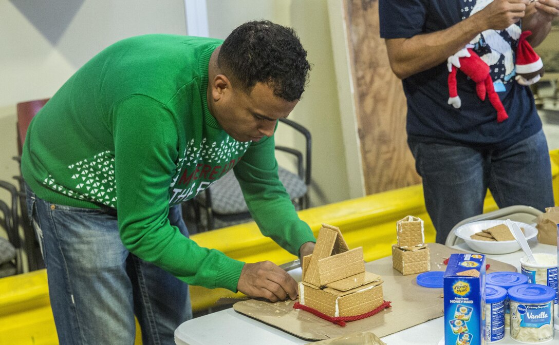 U.S. Marine Gunnery Sgt. Abraham Gonzalez, career planner, I Marine Expeditionary Force Headquarters Group, constructs a gingerbread house during the I MHG Holiday Party at Marine Corps Base Camp Pendleton, Calif., Dec. 14, 2016. The Marines and their family members celebrated the holiday season by building gingerbread houses, decorating stockings and designing Christmas ornaments while enjoying a holiday meal in camaraderie. (U.S. Marine Corps photo by Cpl. Alvin Pujols)