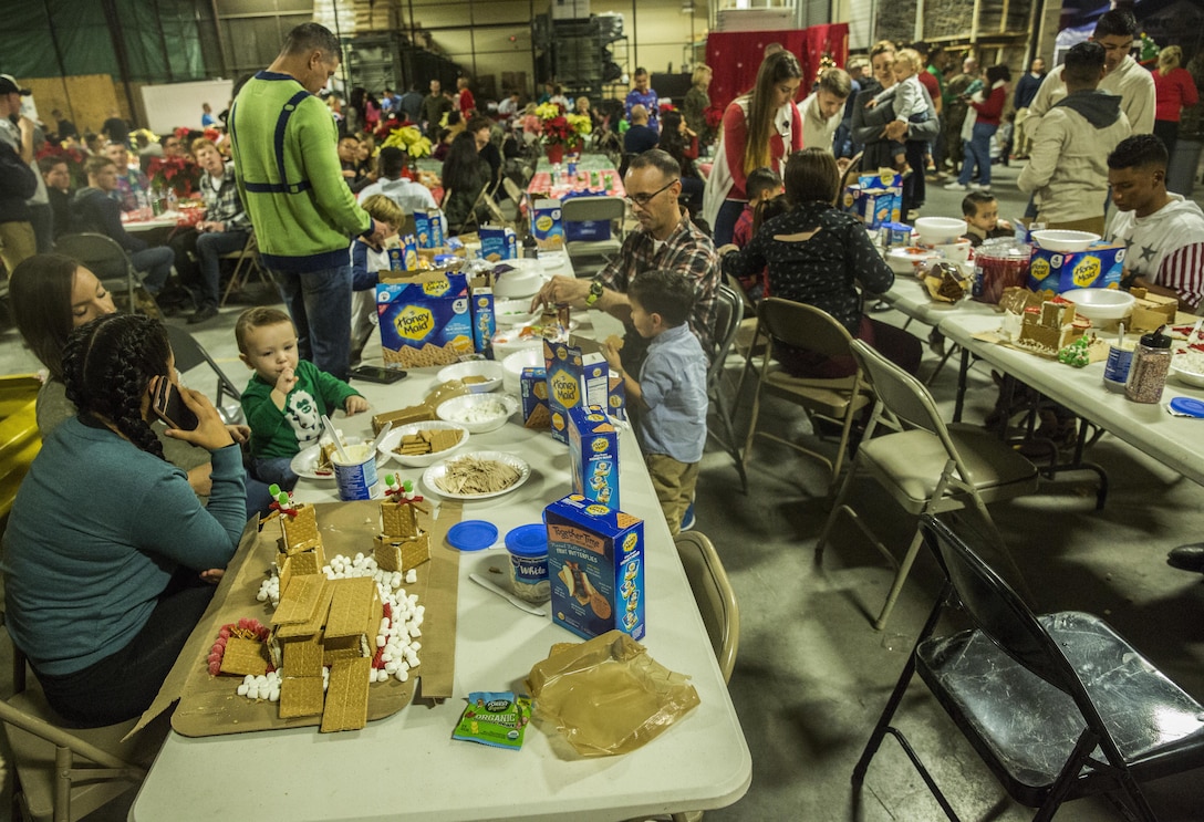 U.S. Marines and their family members  participate in the gingerbread house competition during the I Marine Expeditionary Force Headquarters Group Holiday Party at Marine Corps Base Camp Pendleton, Calif., Dec. 14, 2016. The Marines and their family members celebrated the holiday season by building gingerbread houses, decorating stockings and designing christmas ornaments while enjoying a holiday meal in camaraderie. (U.S. Marine Corps photo by Cpl. Alvin Pujols)