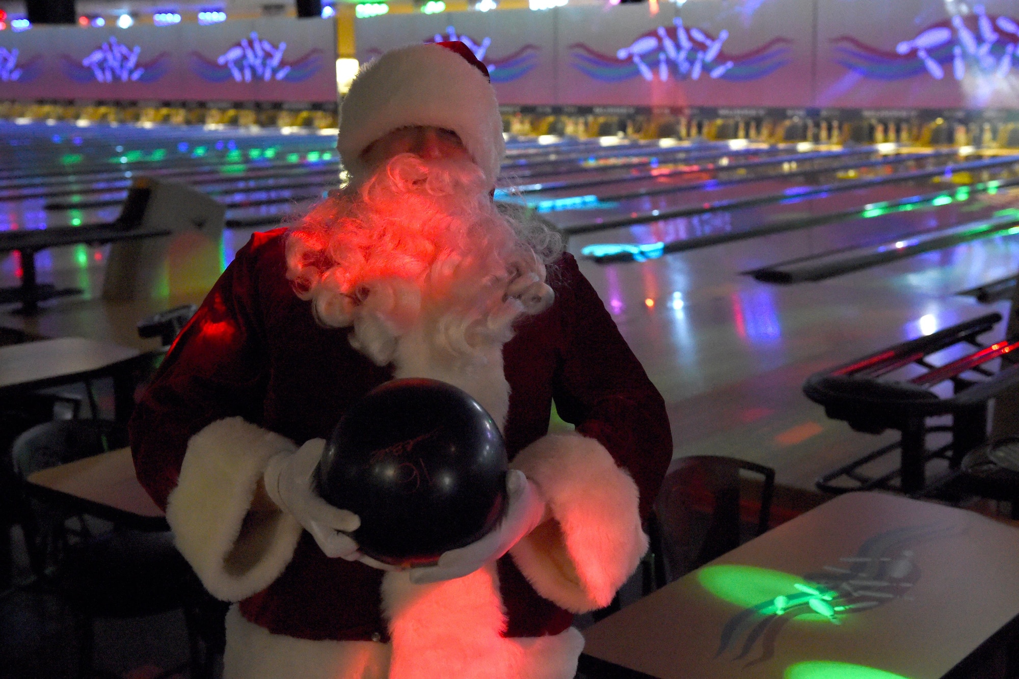 Santa Claus picks a bowling ball at the Joint Base Elmendorf-Richardson Polar Bowl, Dec. 17, 2016. The Polar Bowl hosted a Bowling with Santa event for children of all ages to bowl alongside Santa Claus and receive presents. 
