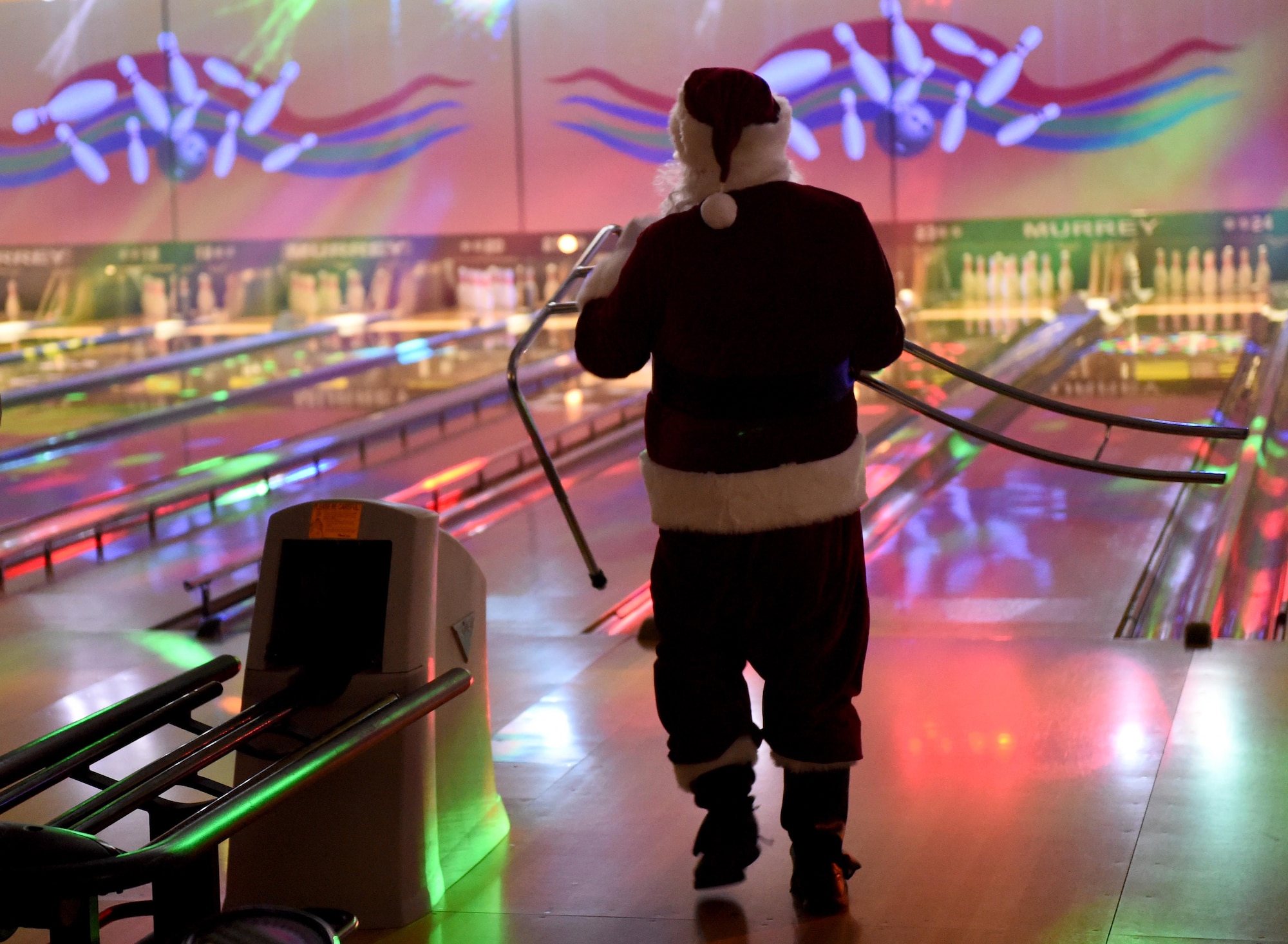 Santa Claus assists bowlers by setting up a bowling ramp at the Polar Bowl at Joint Base Elmendorf-Richardson, Alaska, Dec. 17, 2016. The Polar Bowl hosted a Bowling with Santa event for children of all ages to bowl alongside Santa Claus and receive presents. 