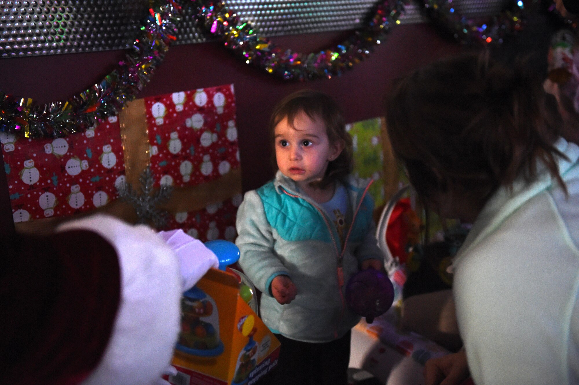 Santa Claus gives Nichole Reinhold, 1, a present at the Polar Bowl at Joint Base Elmendorf-Richardson, Alaska, Dec. 17, 2016. The Polar Bowl hosted a Bowling with Santa event for children of all ages to bowl alongside Santa Claus and receive presents. 
