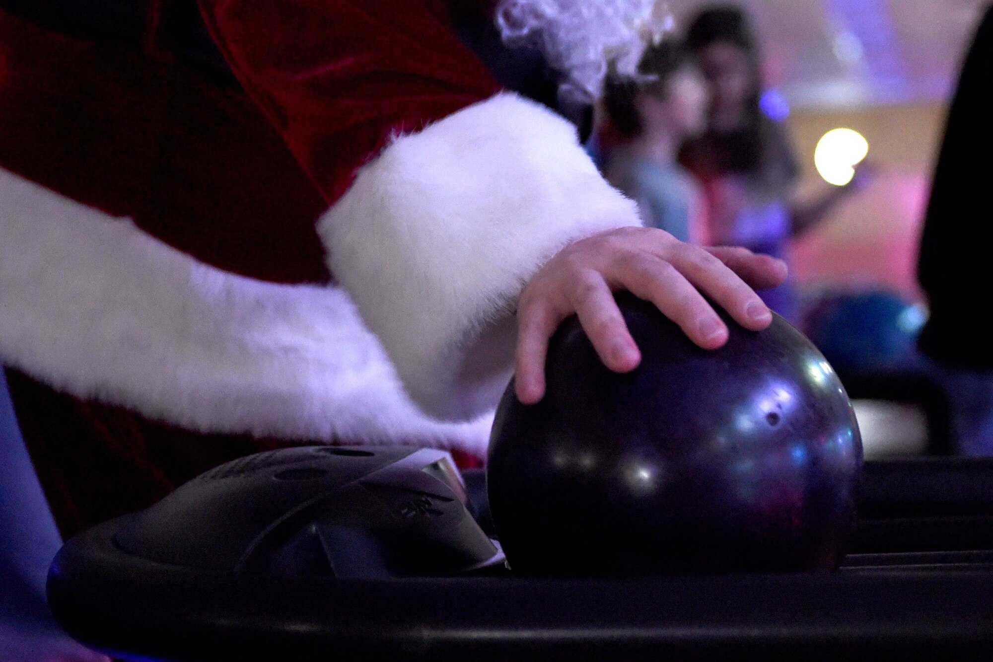 Santa Claus prepares to send his bowling ball down the lane at the Polar Bowl at Joint Base Elmendorf-Richardson, Alaska, Dec. 17, 2016. The Polar Bowl hosted a Bowling with Santa event for children of all ages to bowl alongside Santa Claus and receive presents. 