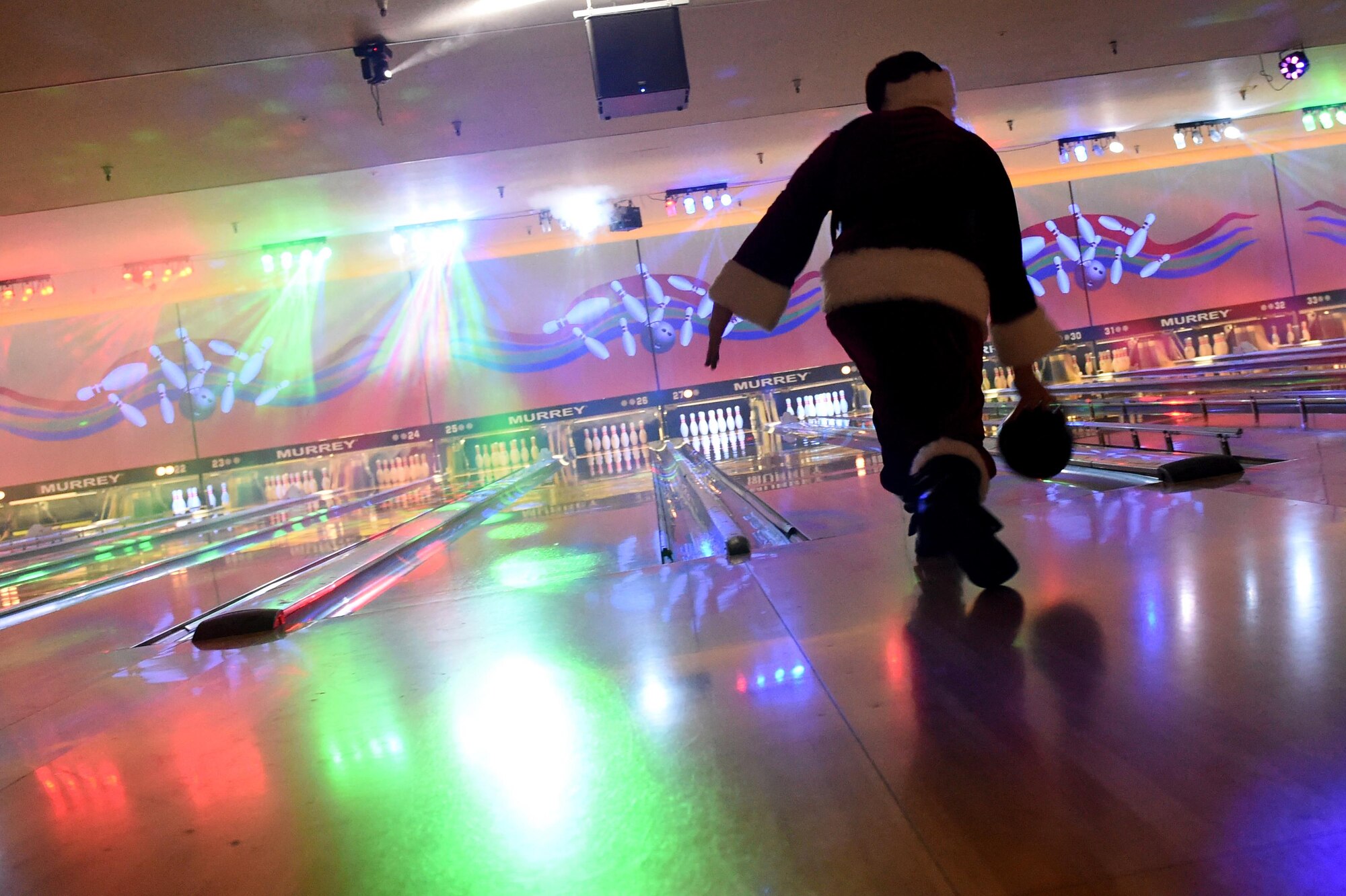 Santa Claus sends his bowling ball down the lane at the Polar Bowl, at Joint Base Elmendorf-Richardson, Alaska, Dec. 17, 2016. The Polar Bowl hosted a Bowling with Santa event for children of all ages to bowl alongside Santa Claus and receive presents. 