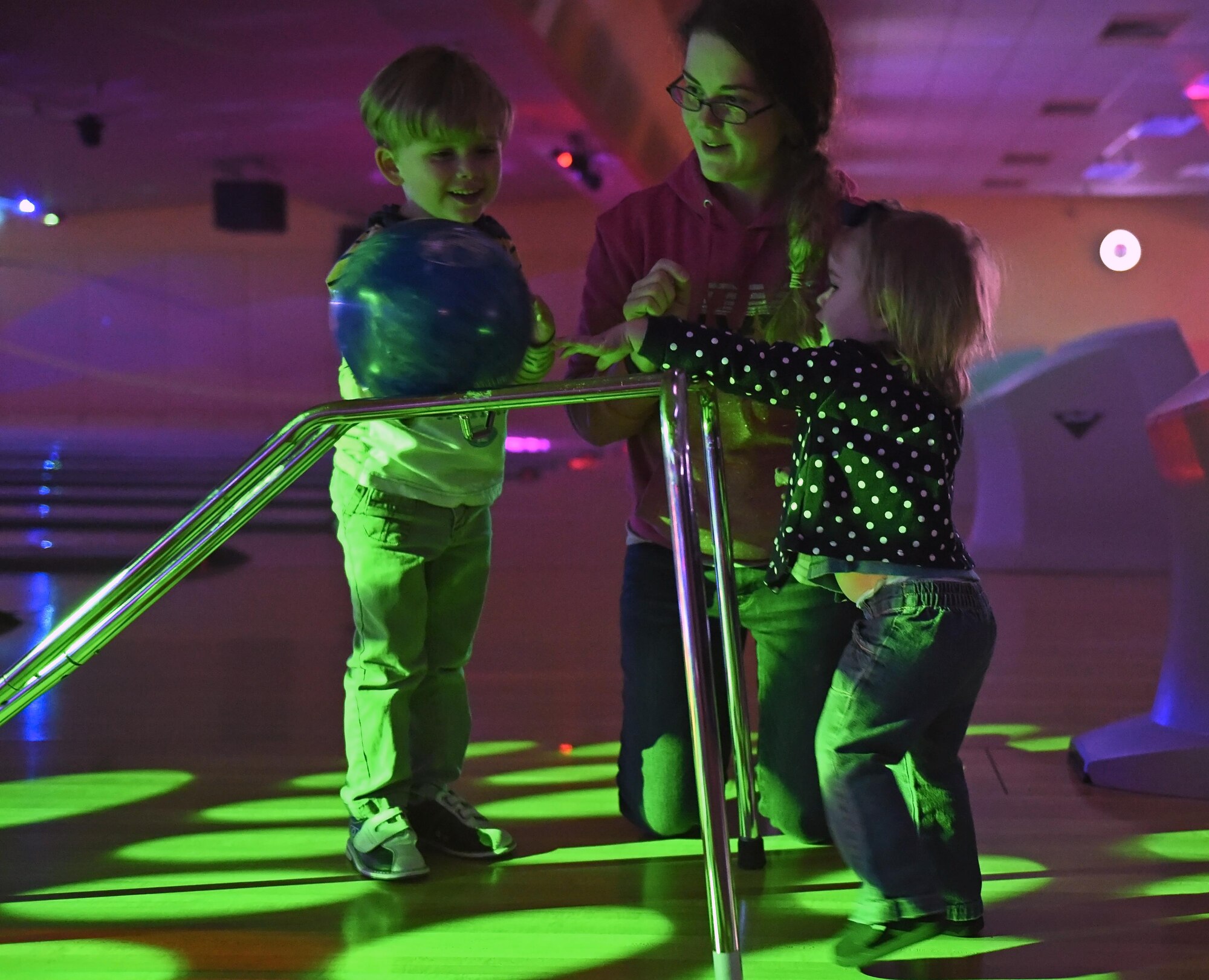 Kayleen Panzer , 1, brother Sean, 6, and mom Collen, ready their throw at the Bowling with Santa event at the Polar Bowl at Joint Base Elmendorf-Richardson, Alaska, Dec. 17, 2016. The Polar Bowl hosted a Bowling with Santa event for children of all ages to bowl alongside Santa Claus and receive presents. 