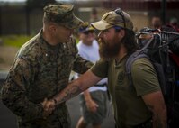 Lt. Col. Bryan Greene, the battalion commander for 2nd Battalion, 4th Marine Regiment welcomes Jon Hancock to Marine Corps Base Camp Pendleton, Calif., Dec. 11, 2016. Hancock walked across the country from Maryland to California honoring his fallen brother and raising awareness for veterans. 2nd Battalion, 4th Marine Regiment held a ceremony honoring his journey. (U.S. Marine Corps photo by Lance Cpl. Frank Cordoba)