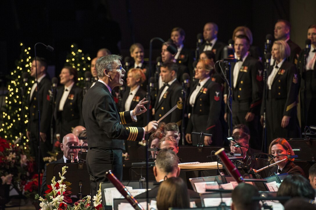 Navy Capt. Kenneth Collins conducts the U.S. Navy Band during a holiday concert at DAR Constitution Hall in Washington, D.C., Dec. 17, 2016. The Navy Band hosted thousands of people from the Washington area as well as hundreds of senior Navy and government officials during its three annual holiday concerts. Navy photo by Chief Petty Officer Adam Grimm